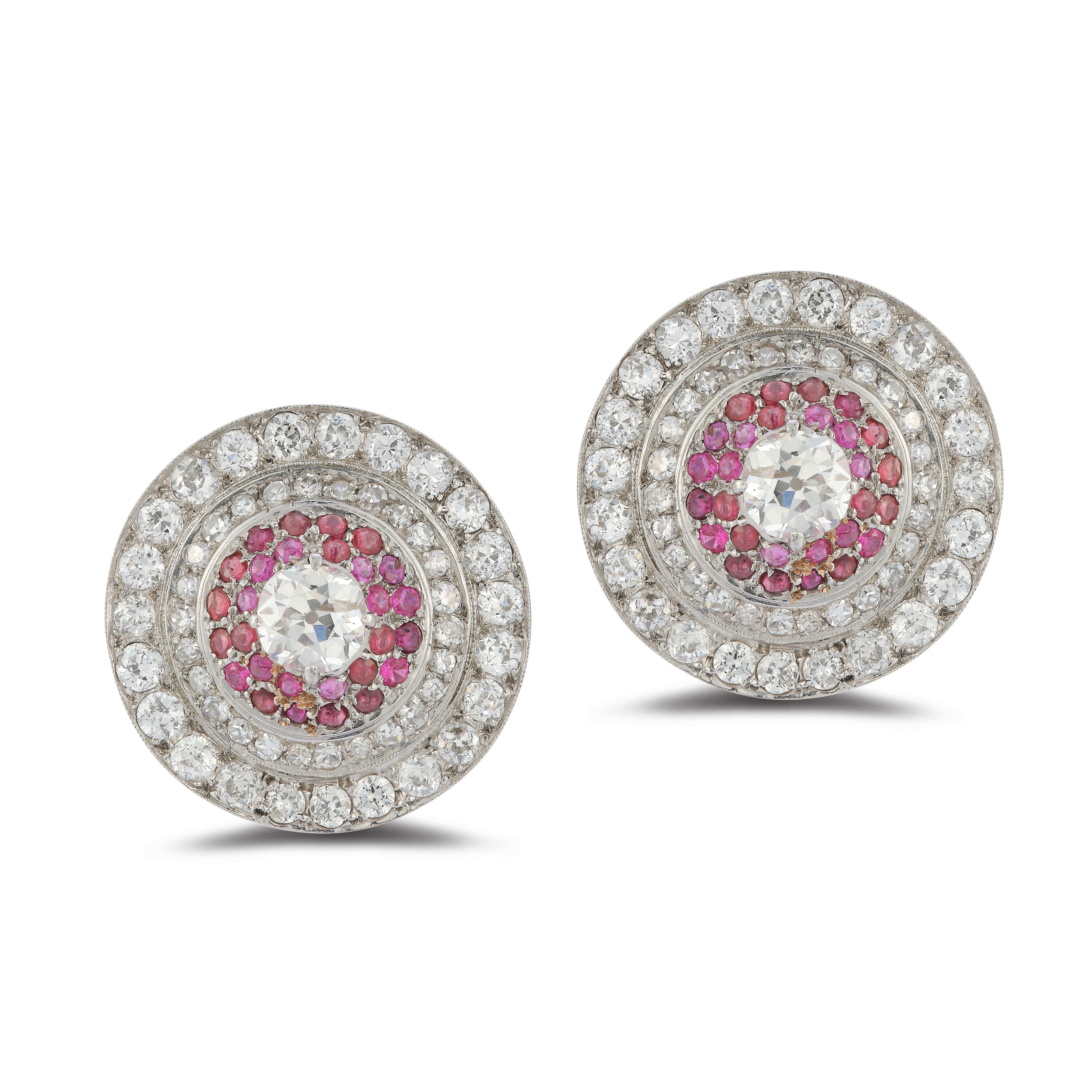 Diamond and Ruby Earclips

Two center round diamonds approx 2.75 ct
Remaining diamonds weigh approx 6.50 cts
Ruby approx 2.10 ct
18 karat white gold