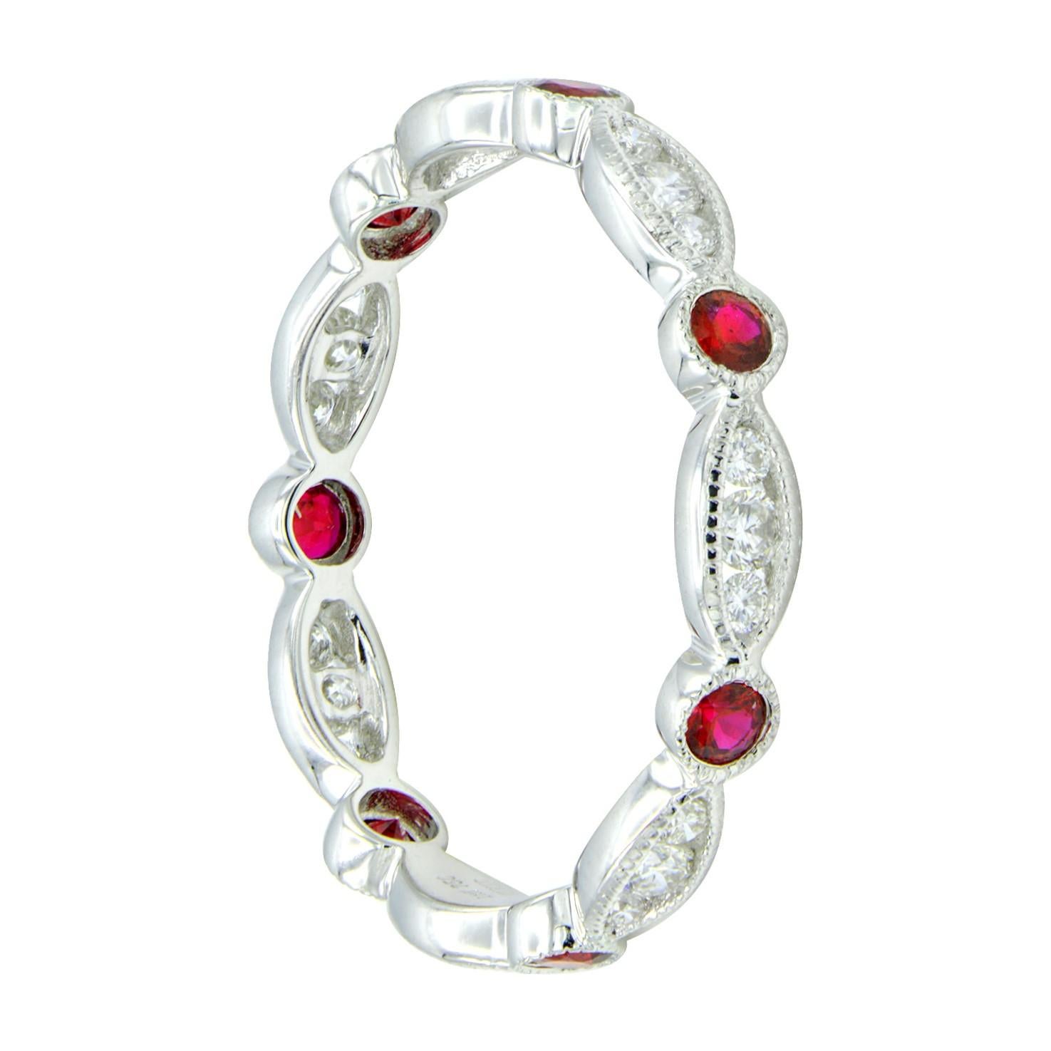 Eternity Rings make an excellent gift, especially this new design. This band contains 7 deep red rubies totaling 0.30 carats with 21 round VS2, G color diamonds in between totaling 0.30 carats. Which are set in 1.6 grams of 18 karat white gold. 