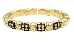 Bracelet manchette flexible en or jaune 18 carats avec motif de fleurs en diamant et rubis