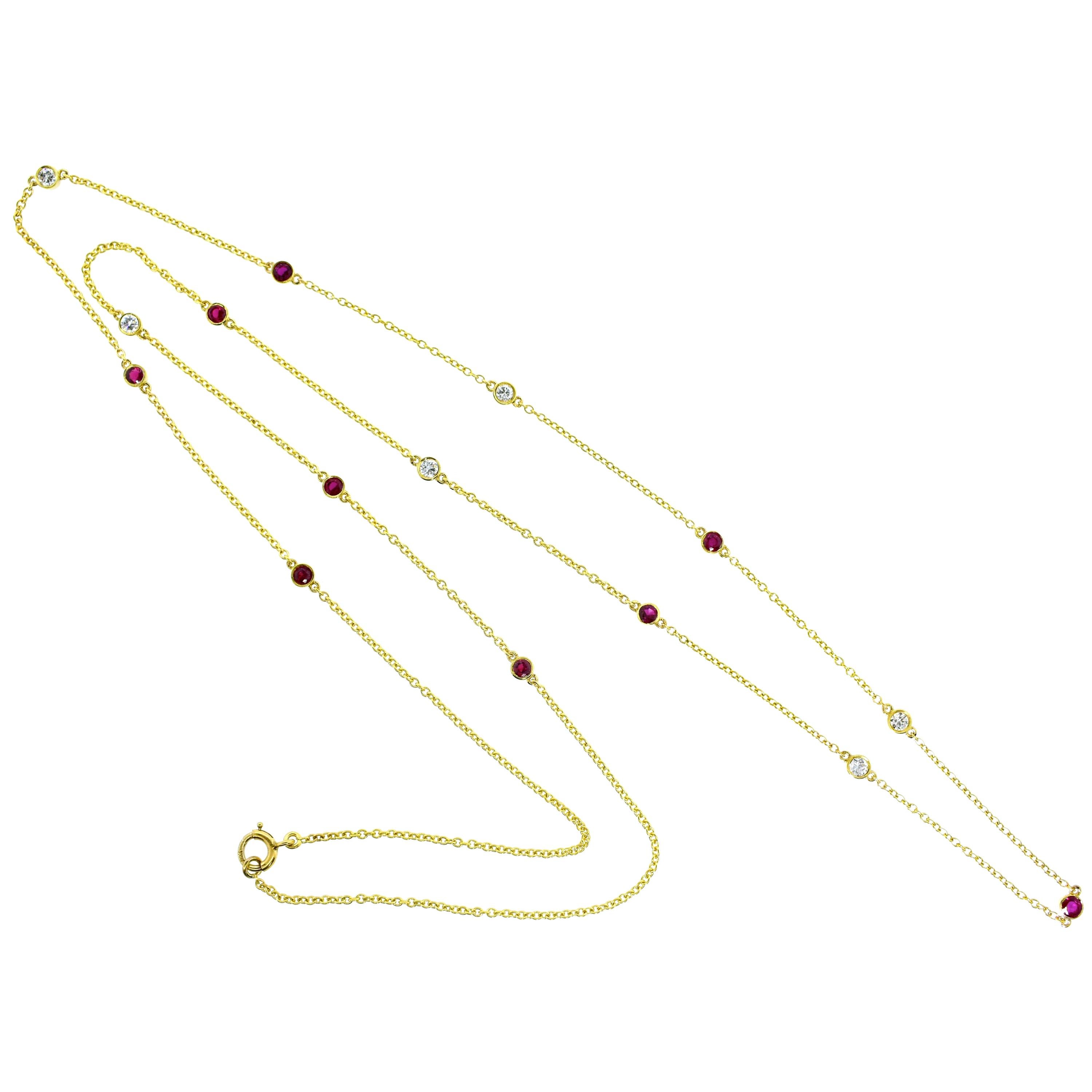 Ruby and diamond long gold chain, 30 inches in length, weighing 5.85 grams.  There are 6 round brilliant cut diamonds all H color and VS in clarity.  The total diamond weight is .50 cts., there are 9 fine red natural rubies all matching well in