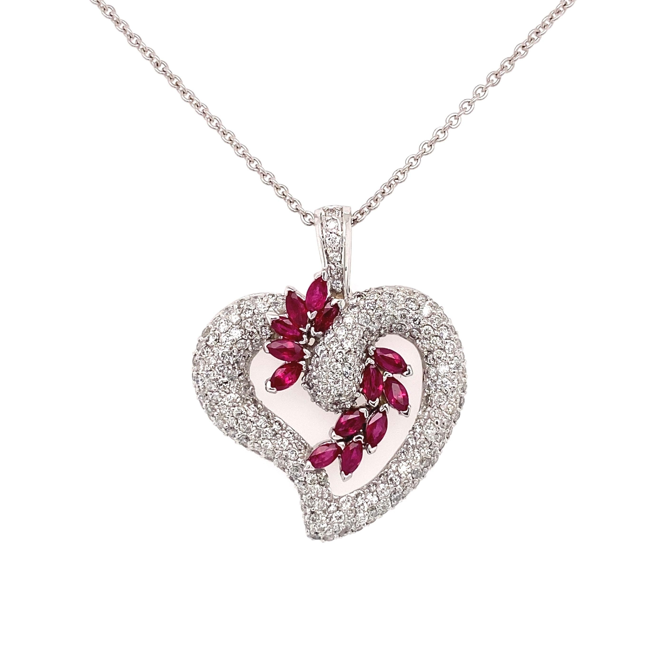 Simply Beautiful! Diamond Heart Pendant accented by Rubies, suspended from a 14K White Gold 18” chain. Hand set Diamonds, weighing approx. 2.18tcw and Rubies approx. 1.48tcw. Hand crafted 14K White Gold mounting. Pendant measures approx. 1.35” L x
