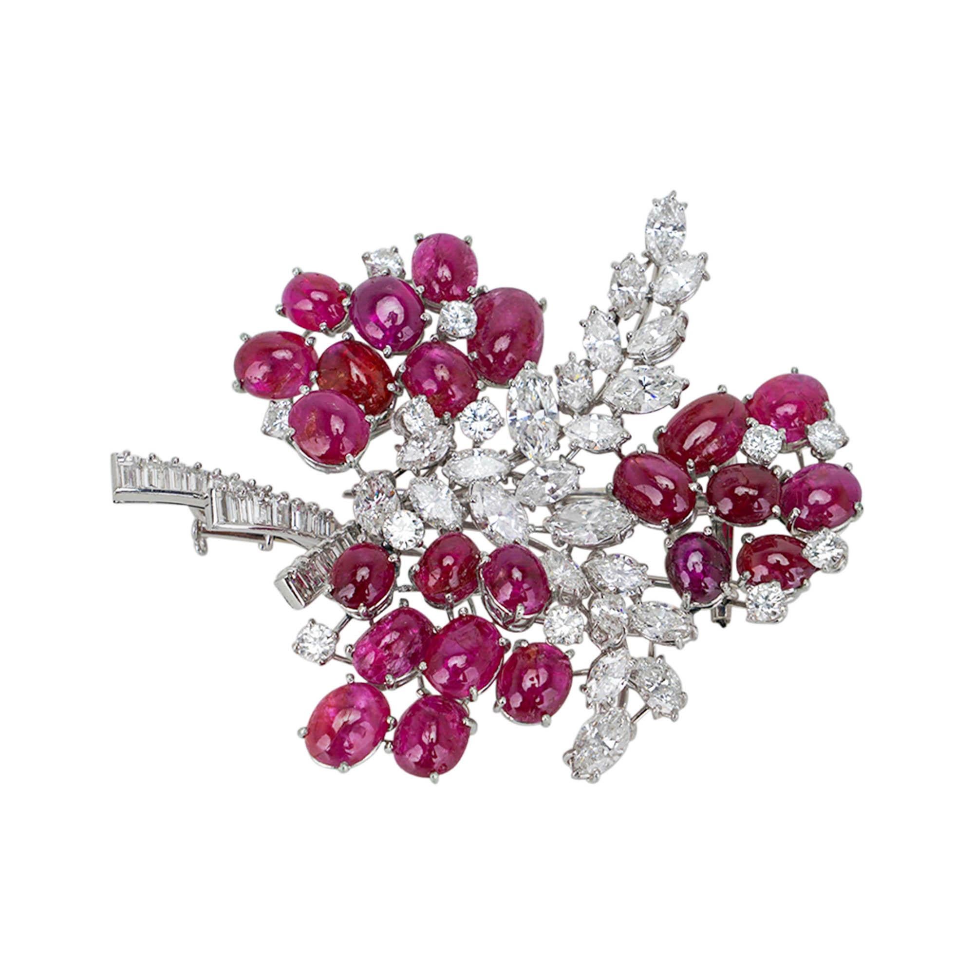 Unbranded vintage circa 1970s' Diamond and Ruby Brooch set in Platinum.
A stunning brooch with 24 Marquise Diamonds Vs1/Vs2 quality +- .25 each for a total of 6 CT.
Interspersed among 23 Cabochon Rubies with +- 13.8 CT.
12 Round Diamonds Vs1/Vs2
