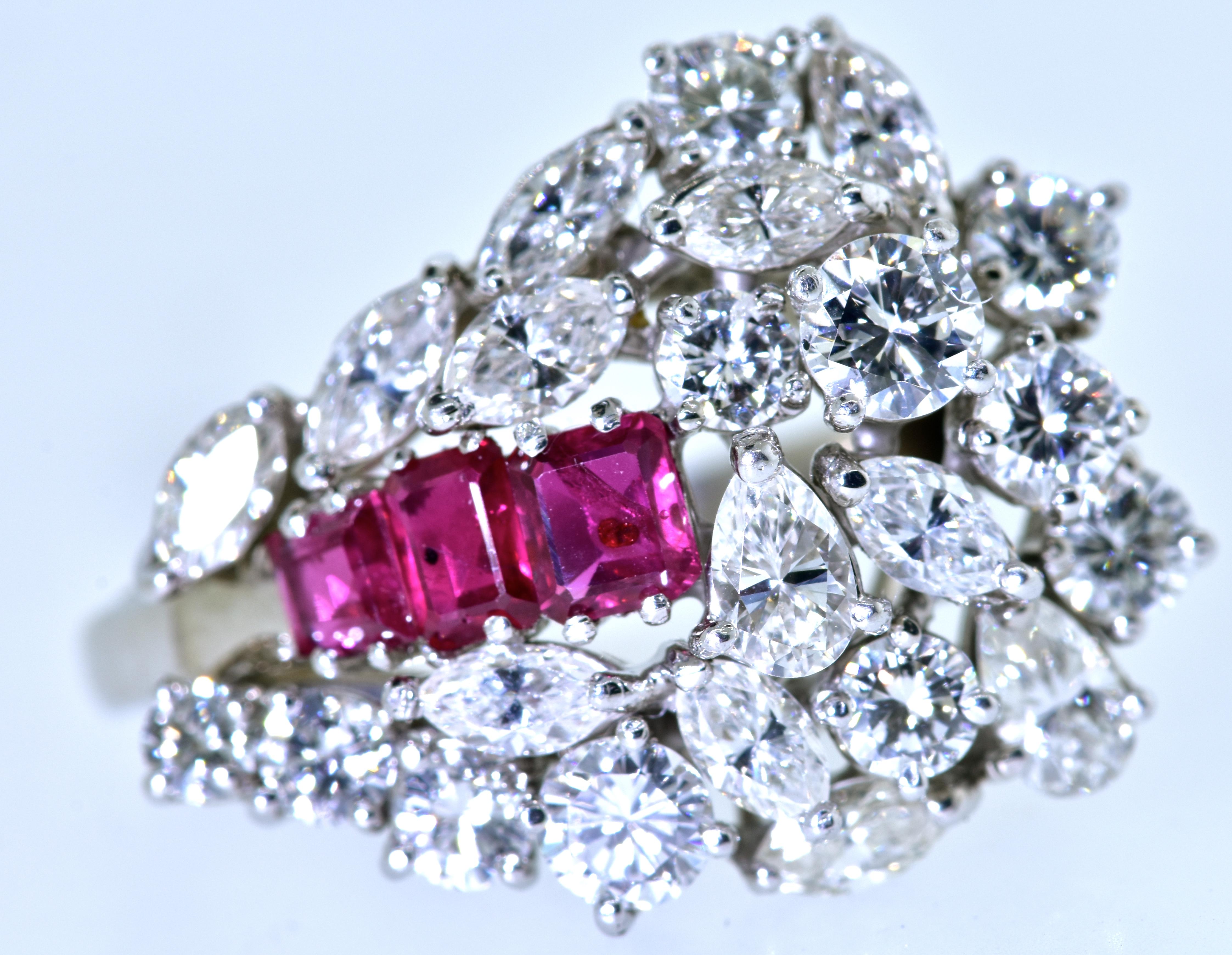 Platinum diamond and ruby well made ring.  White prong set diamonds, both marquis and round brilliant cut diamonds are set in a pleasing cluster.  These diamonds are all well cut with fine symmetry.  They are all near colorless, H, and very slightly