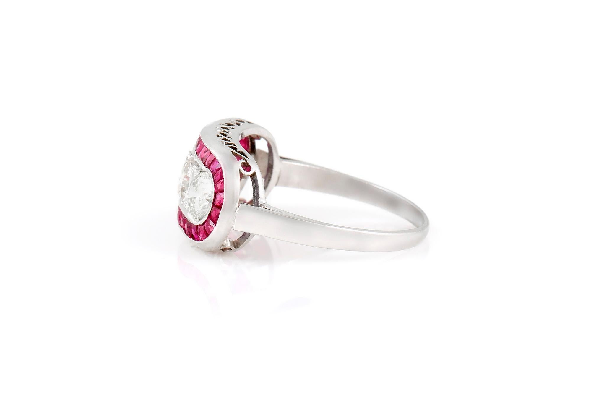 This ring is finely crafted in platinum with round brilliant cut diamonds weighing approximately a total of 1.20 carat and rubies weighing approximately a total of 1.20 carat. Circa 1970's.