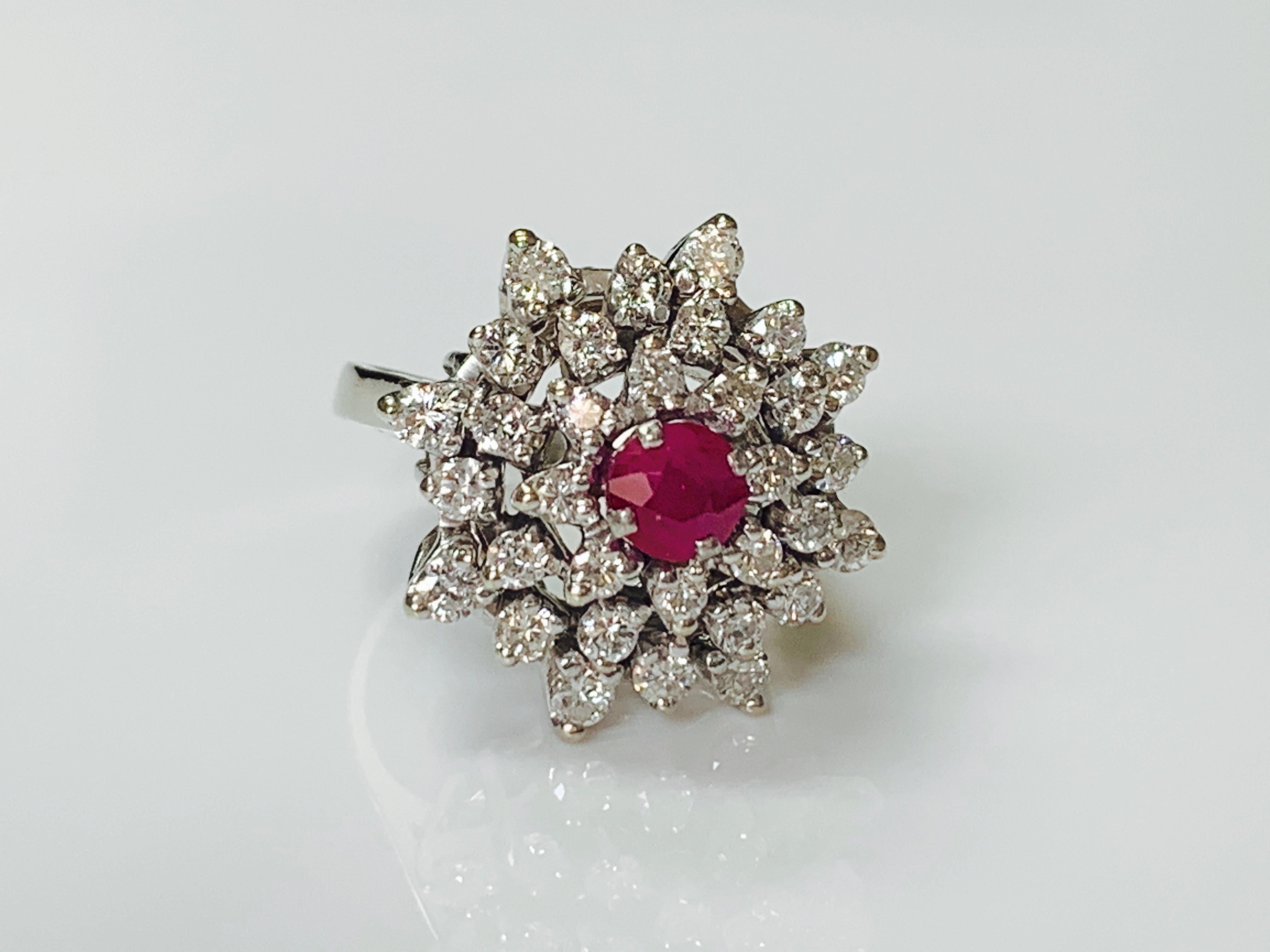 Ruby and diamond ring handcrafted in 14k white gold. 
The details are as follows : 
Diamond weight : 1.25 carat ( SI1 clarity and I color ) 
Ruby weight : 0.55 carat 
Metal : 14K white gold 
