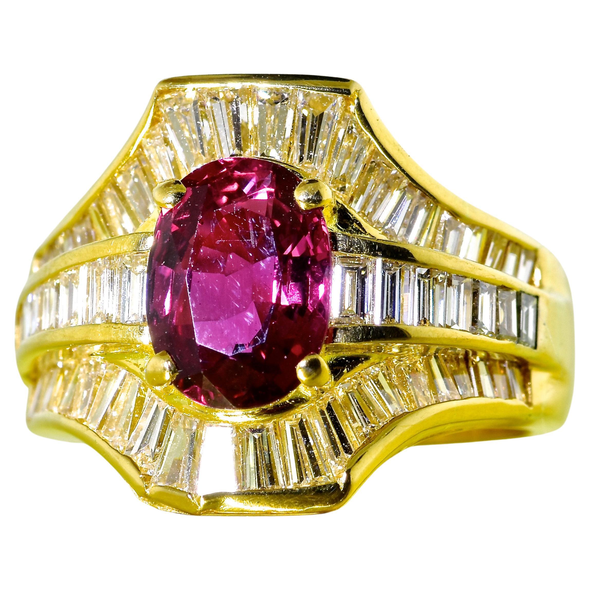 Diamond and natural ruby ring with fine and white diamonds, the natural ruby is a pure natural red all  hand set in 18K yellow gold.  The center oval cut natural ruby displays a bright red color.  This stone is very clean, well cut with fine