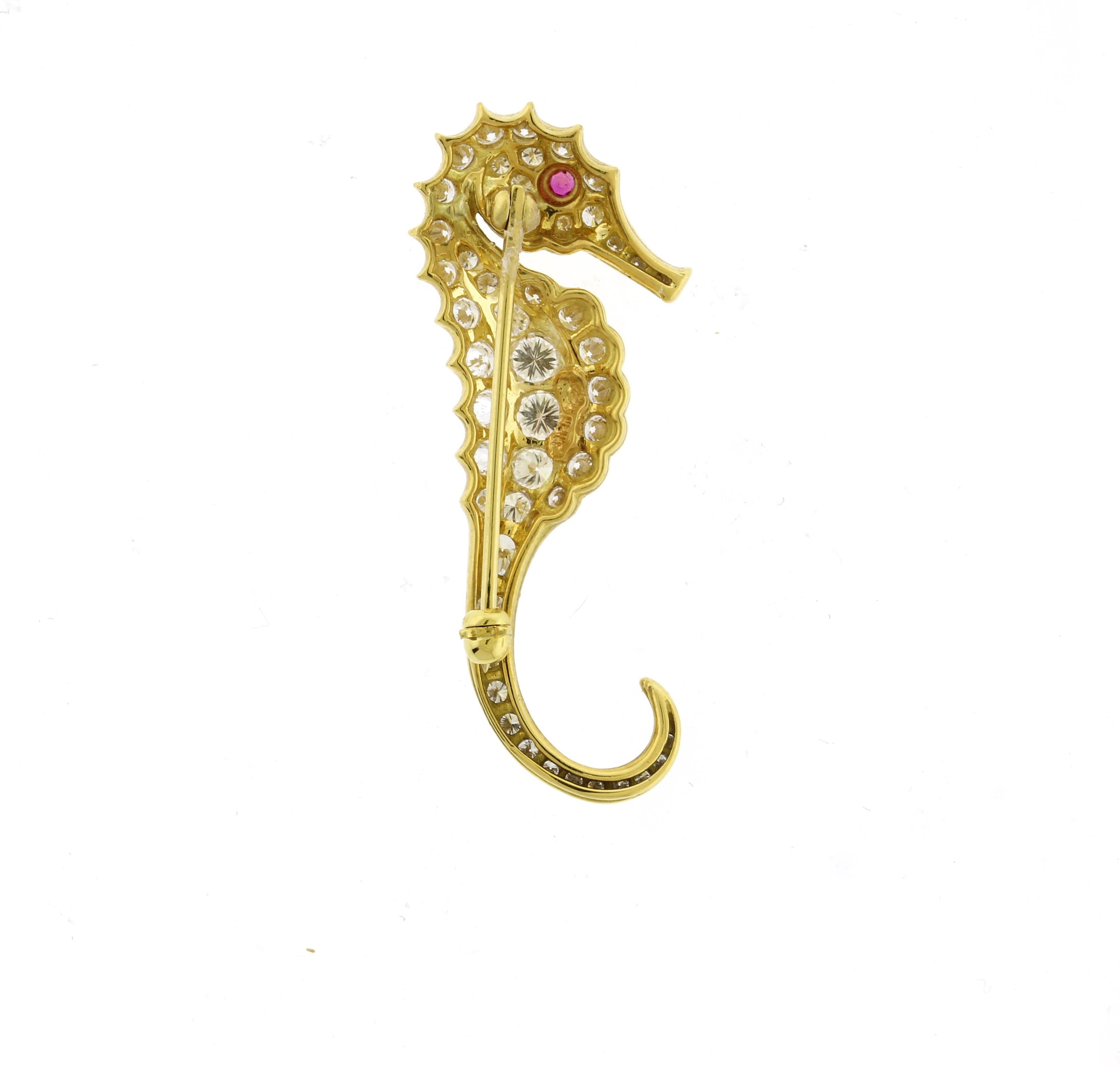 This gorgeous brooch has 1.78 carats of diamonds.  The seahorse is about 1.5 inches in length.
• Metal: 18kt Yellow Gold
• Designer: Pampillonia Jewelers
• Circa: 2023
• Gemstone: Ruby and Diamonds
• Diamonds: 51=1.78carats
• Packaging: Pampillonia