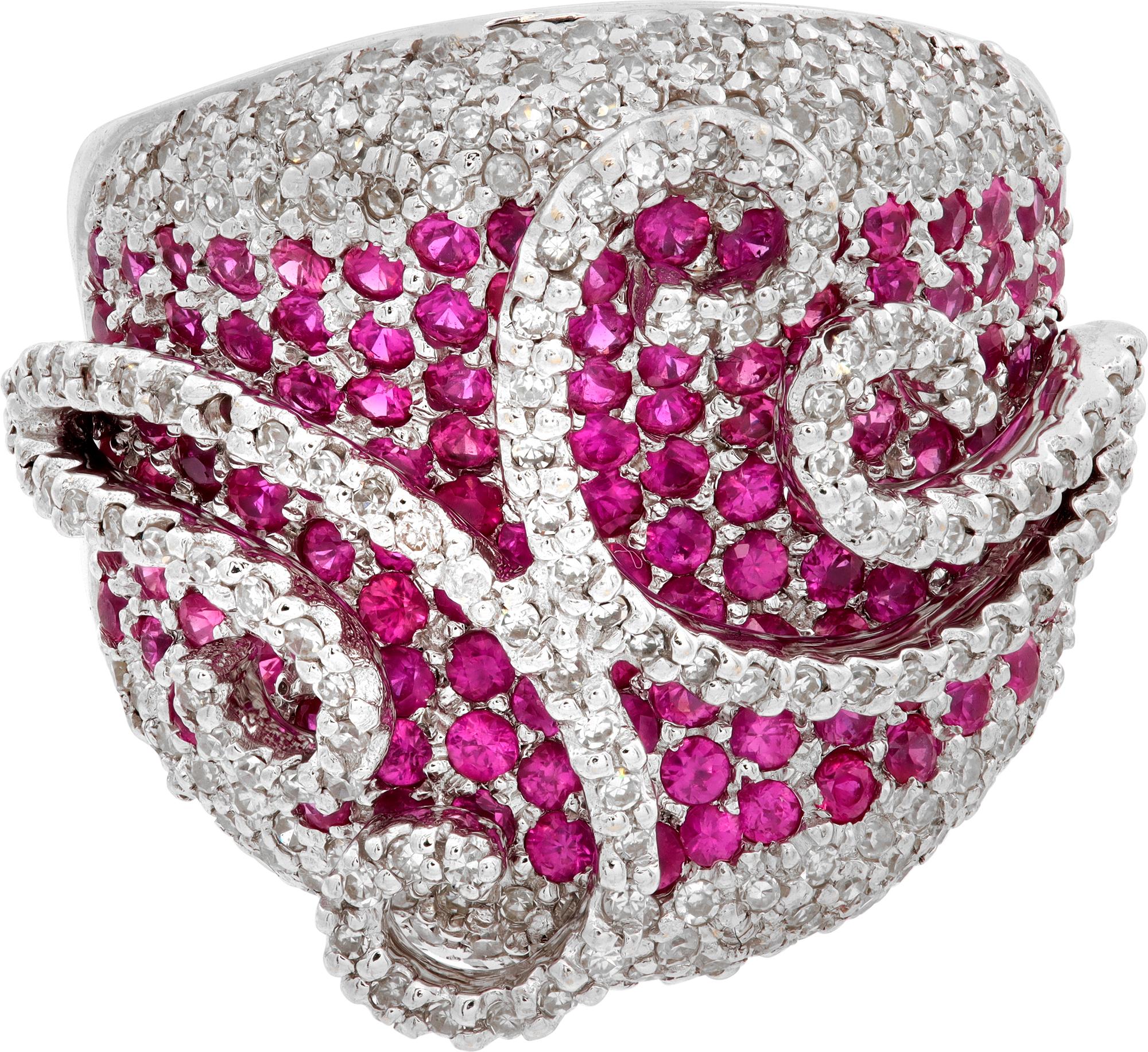 Diamond and Ruby Swirl ring in 18K white gold. Round brilliant cut diamond total approx. weight: 2.00 carats, estimate G-H color, VS clarity. Round brilliant rubies total approx. weight: 1.00 carat. Front ring measurements: 23 x 30mm (7/8 x 1 1/8