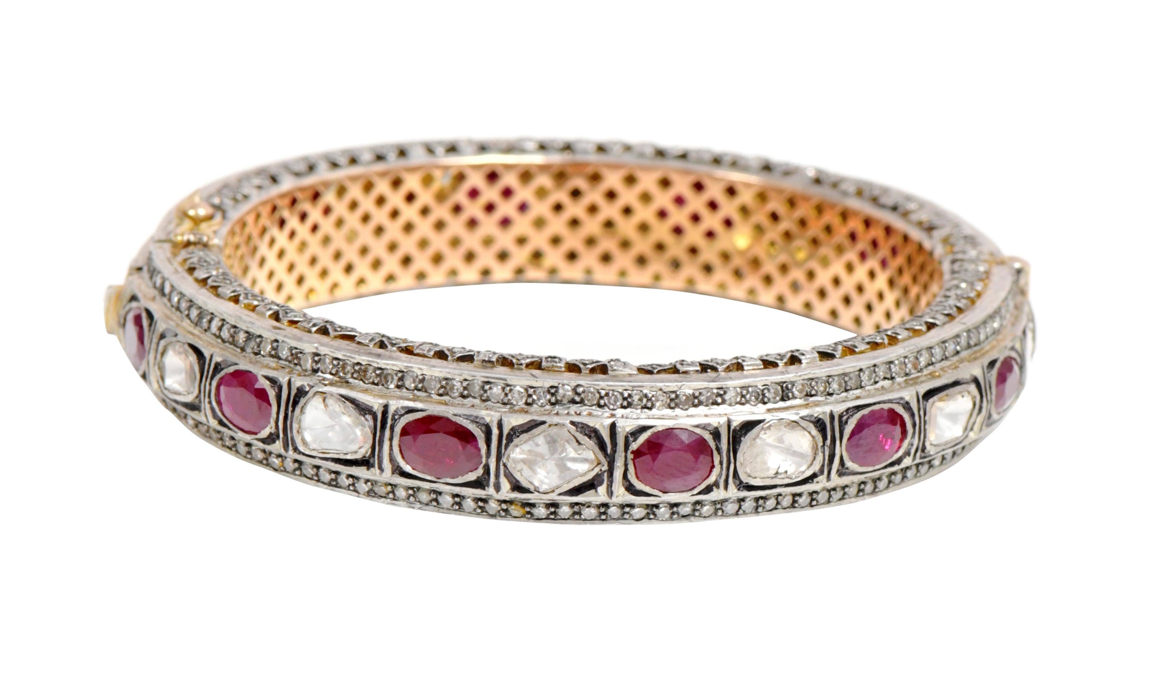 Diamond and Ruby Tennis Bangle in Art-Deco Style

This Victorian period art-deco atypical polki diamond and wine red ruby bangle is sensational. The uneven triangle and U-cut flat polki diamond solitaires alternated with oval shape solitaire rubies