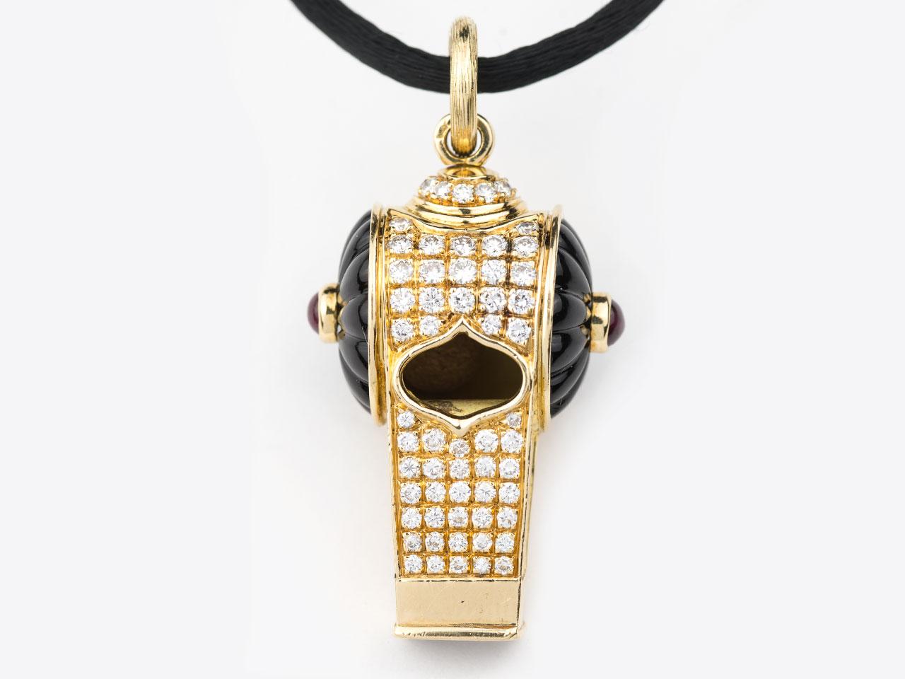 18k gold diamond set whistle pendant set with 1.08 carats of diamonds and .61 carat of rubies. Signed 750 with makers mark.