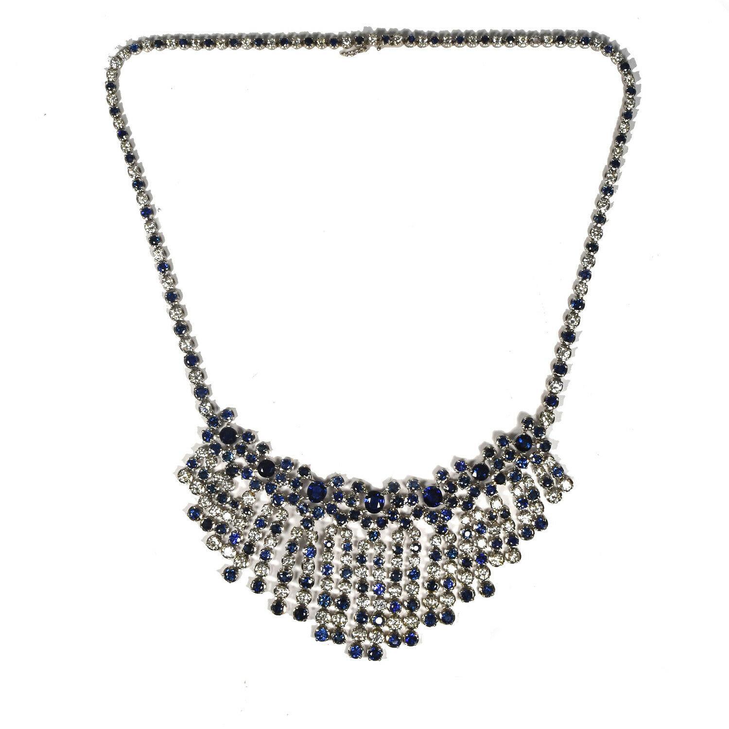 This bib Necklace reflects a genuinely sophisticated and elegant look. It is a stunning piece made of 18k white gold, set with approximately 138 round brilliants and 180 round sapphires, creating a contrast that makes this piece even more