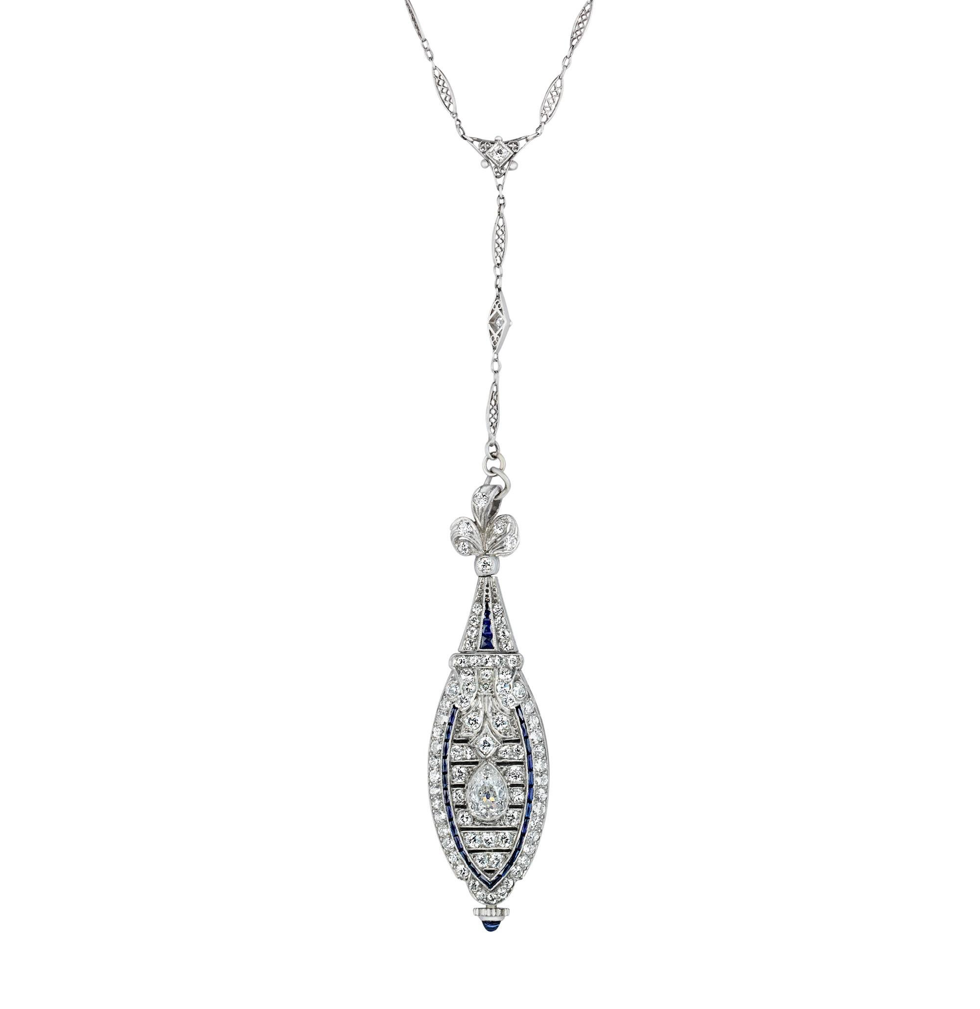 Attached to a handmade Y-shaped chain, this rare French diamond and sapphire-studded platinum watch pendant embodies Art Deco charm and sophistication. The elegant timepiece contains 4.50 total carats of diamonds and 0.75 carat of sapphires. The