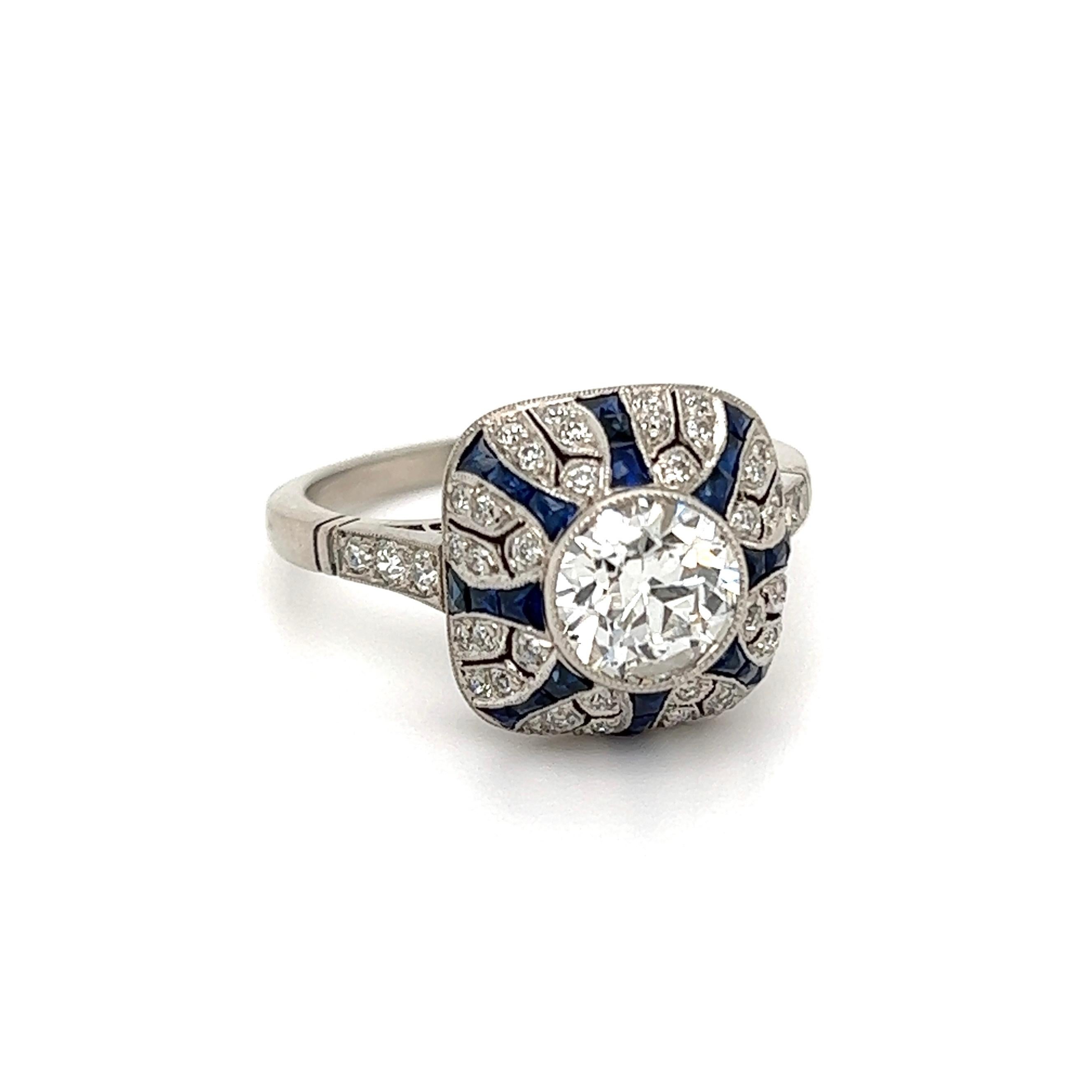 Simply Beautiful! Finely detailed Cocktail Ring, center securely Hand set with an Old European Cut Diamond, approx. total carat weight of Diamonds 1.10 Carats, accented by Sapphires weighing approx. 1.30tcw and Diamonds, approx. 0.78tcw. Hand