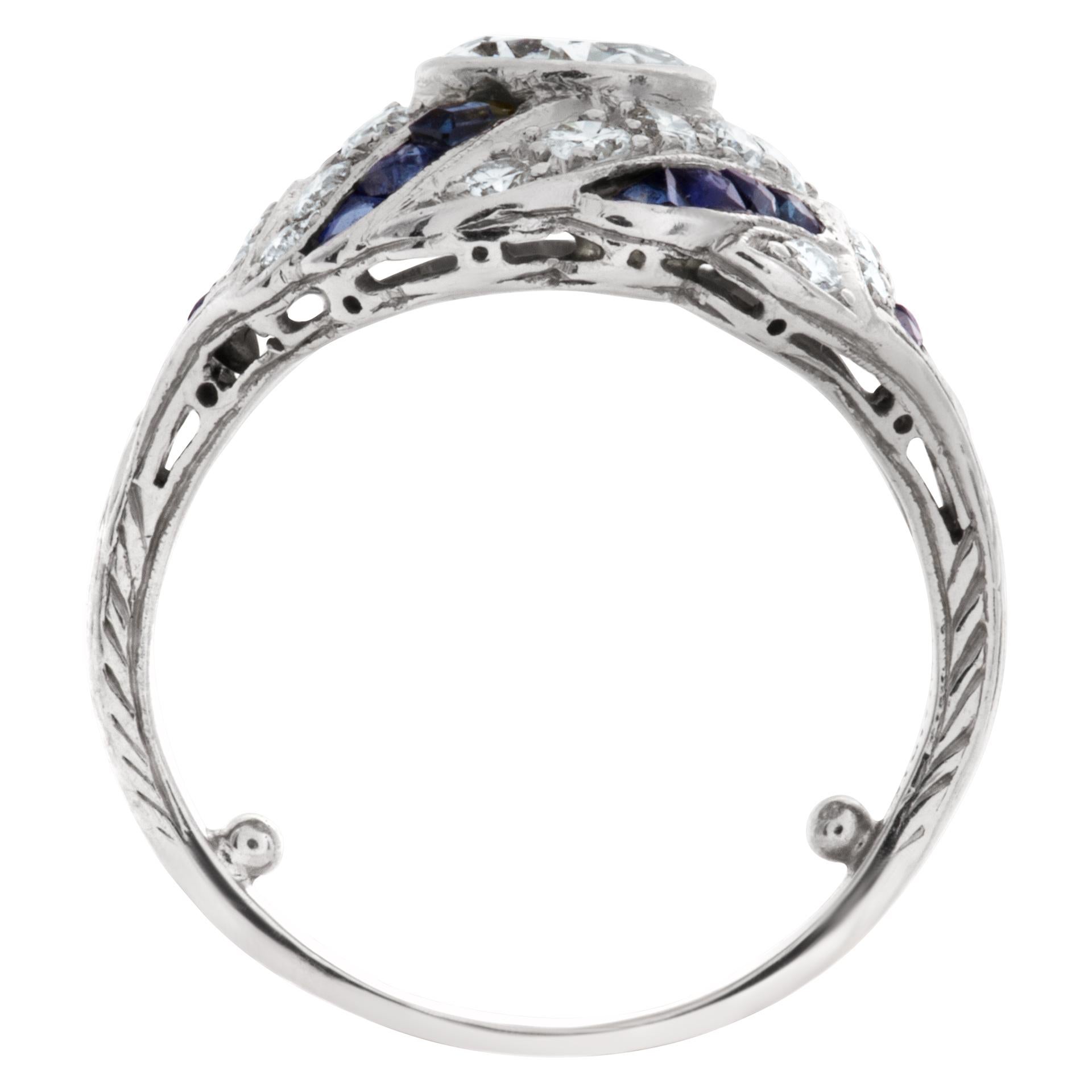 ESTIMATED RETAIL $7,000.00 - YOUR PRICE $4,250.00 - Diamond and sapphire Art Deco ring in platinum with center Old European cut diamond (0.75 carats J-K color, SI clarity) surrounded by 0.75 carats in a swirl of diamonds and 0.75 carats in mixed-cut