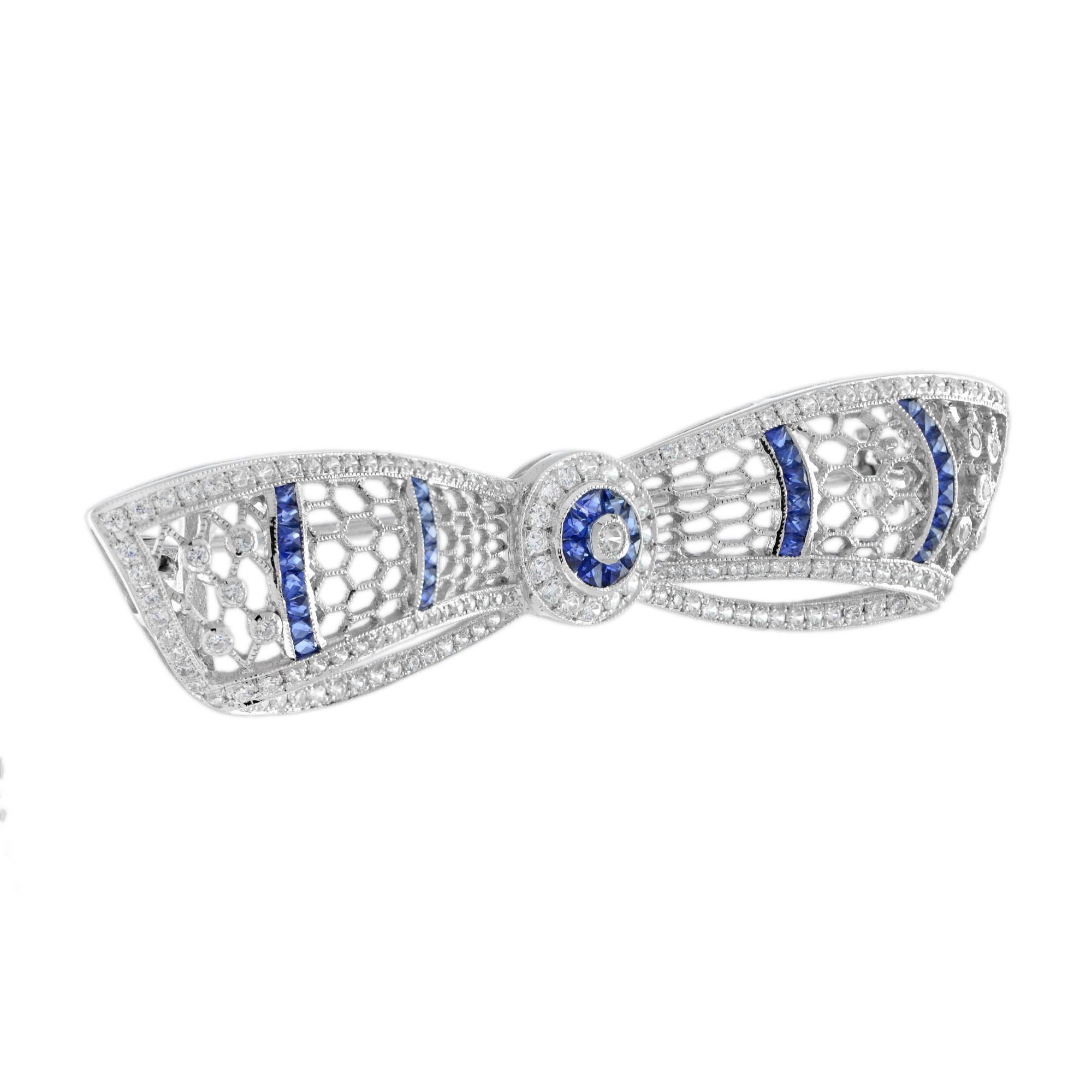 A truly beautiful white gold bow brooch set with diamonds and French cut sapphires. The milgraining of the metal edges allow the diamonds and gemstones to sparkle without competing with the reflected light from a highly polished white gold edge.