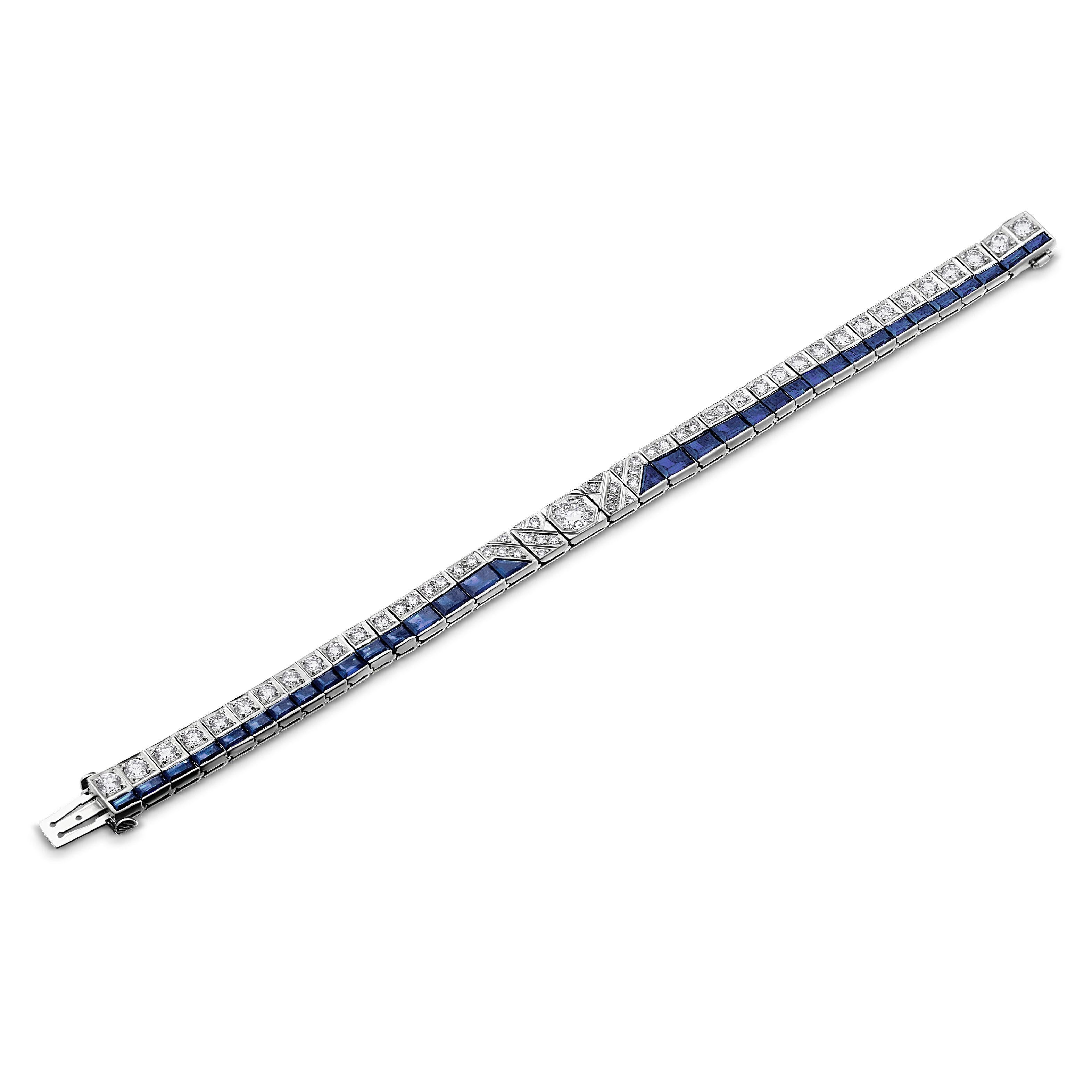 Simply Beautiful! Elegant and finely detailed Art Deco Revival Diamond and Blue Sapphire White Gold Bracelet. All Diamonds are round Brilliant-cut and Hand set; VS2; H color. Center Diamond, approx. 0.64 Carat, 8 Diamonds, approx. 1.28tcw, 16