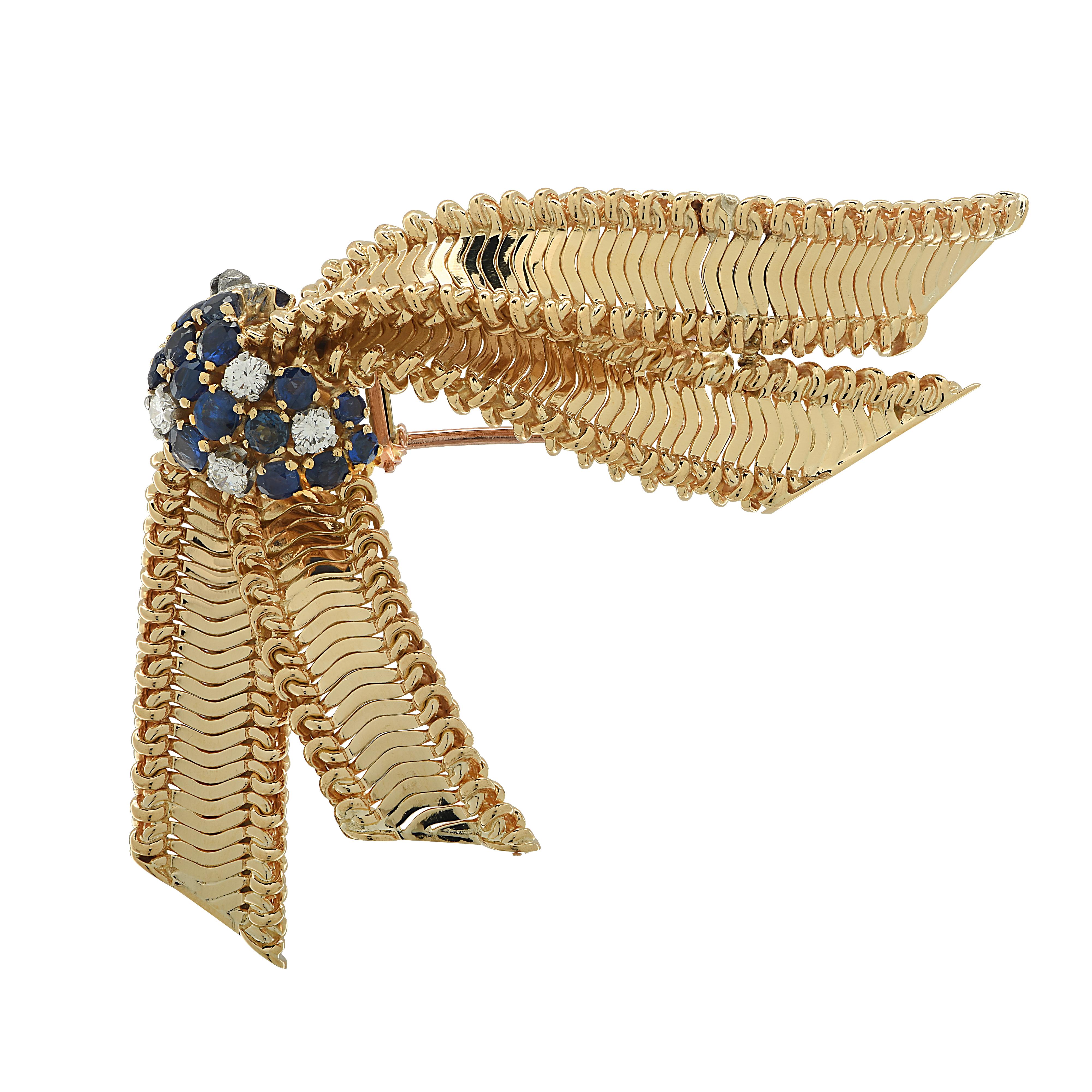 Enchanting brooch pin crafted in 18 karat yellow gold, featuring 6 round brilliant cut diamonds weighing approximately .50 carats total, G color, VS-SI clarity and 17 round blue sapphires weighing approximately 1 carat total. This delightful brooch