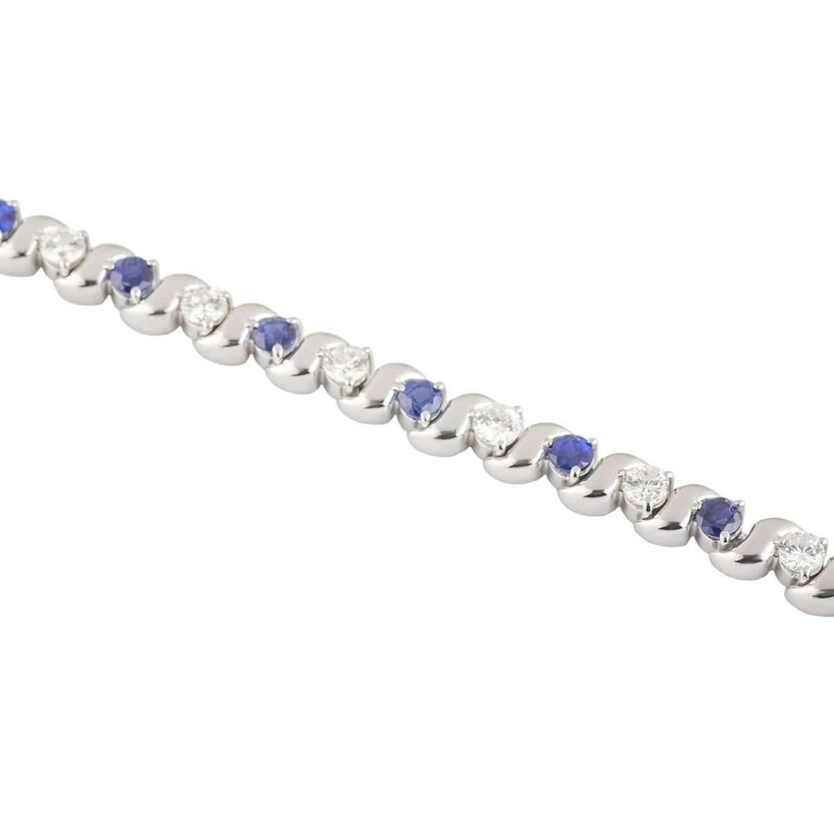 A beautiful 18k white gold diamond and sapphire bracelet. The bracelet comprises of round brilliant cut diamonds alternating in a wave design with round brilliant cut sapphires. The diamonds have a total weight of approximately 1.95ct, G colour and