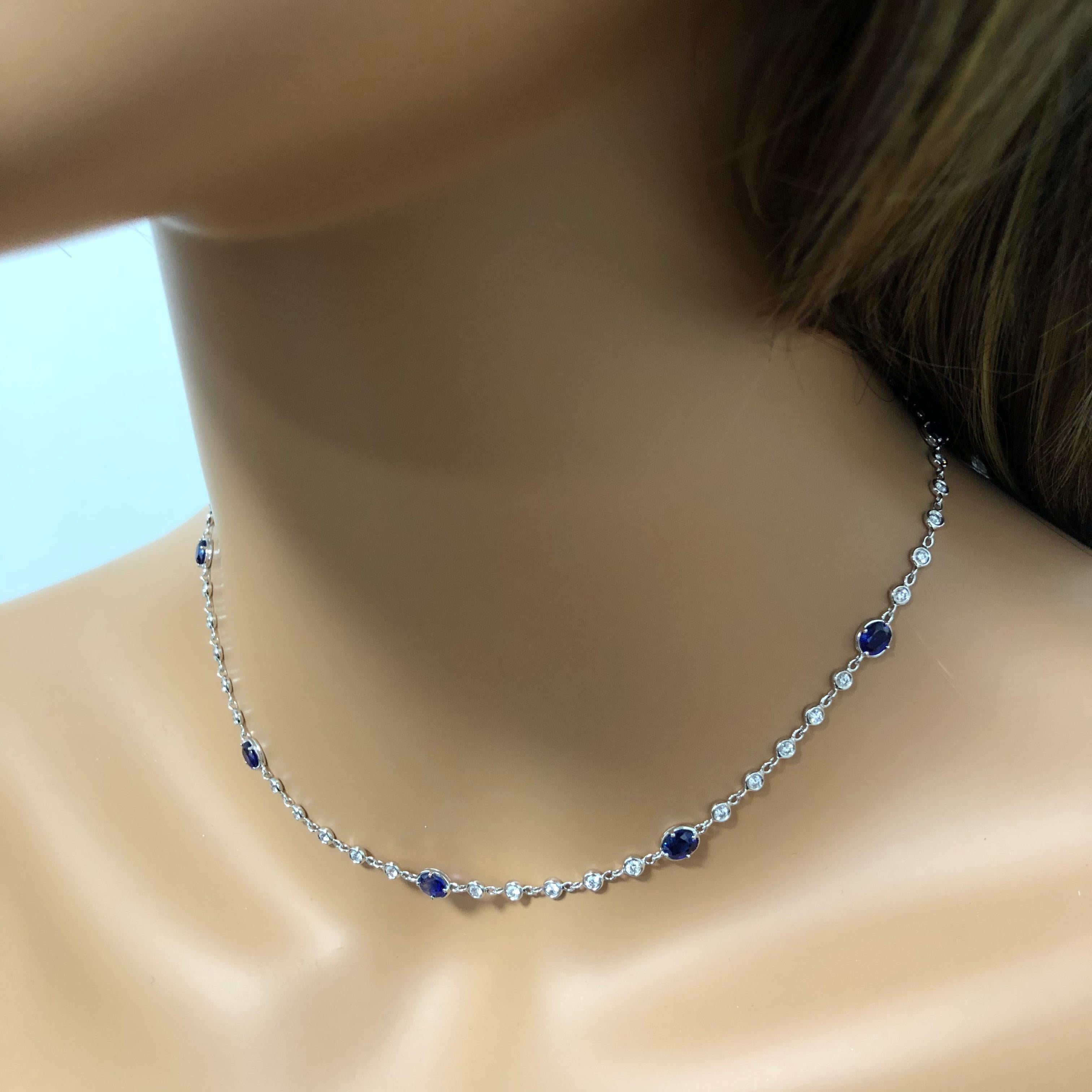 A unique take to the classic diamond by the yard necklace. Features 9 vibrant oval cut  blue sapphires weighing 4.00 carats total elegantly spaced by sparkling round diamonds. Diamonds weigh 1.34 carats total. 18k white gold composition. 

Style