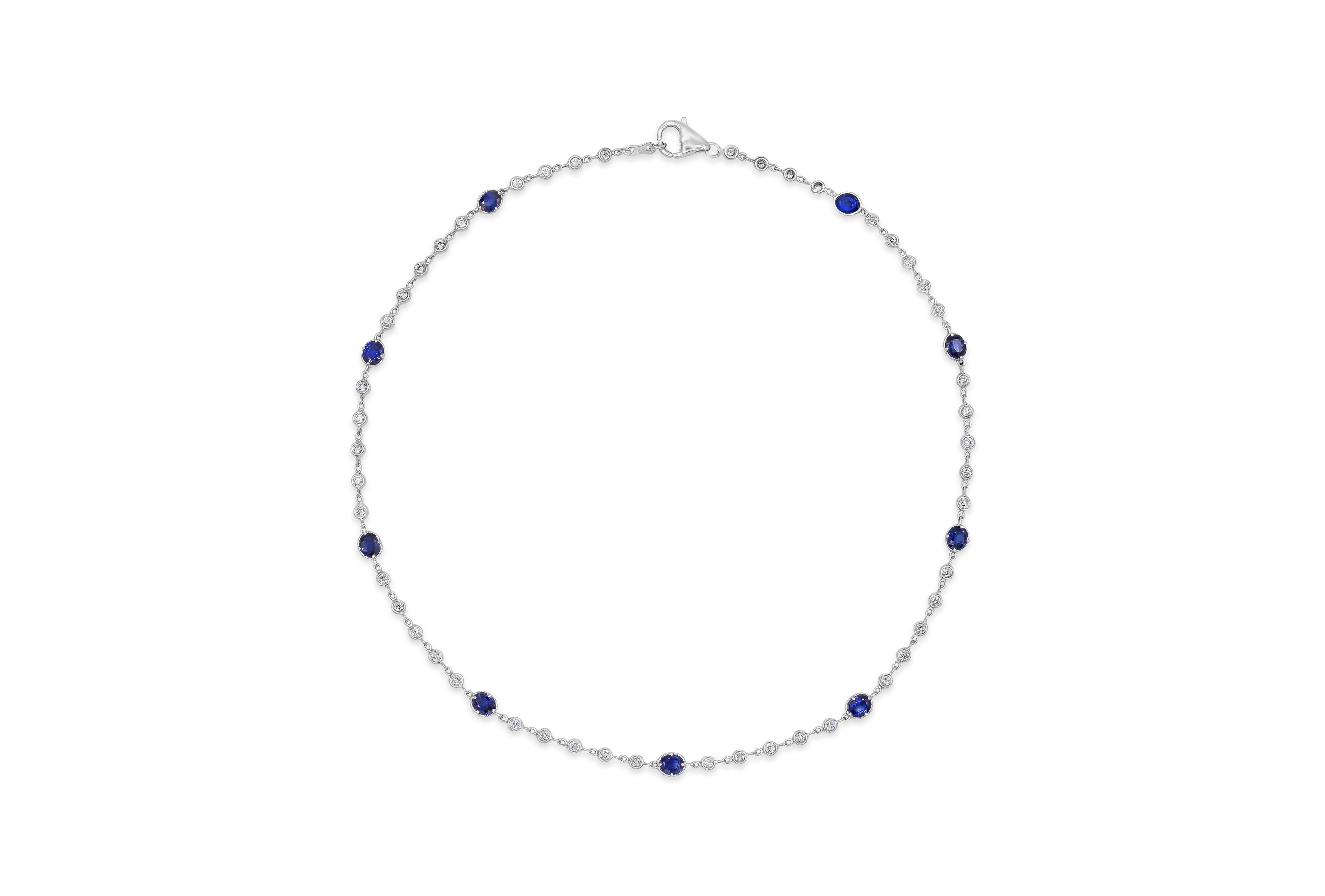 A unique take to the classic diamond by the yard necklace. Features 9 vibrant oval cut blue sapphires weighing 4.00 carats total elegantly spaced by sparkling round diamonds. Diamonds weigh 1.34 carats total.  Mounted in 18k white gold