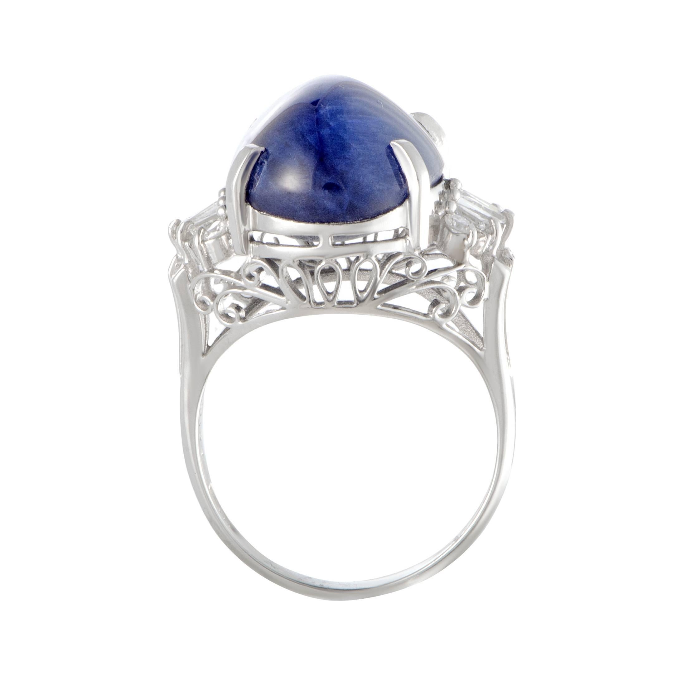 Set against the opulent backdrop of prestigiously gleaming platinum and luxuriously scintillating diamonds, the sapphire in this ring compels with its regal color and marvelous cut. The sapphire weighs 18.50 carats, and it is accompanied by 0.34