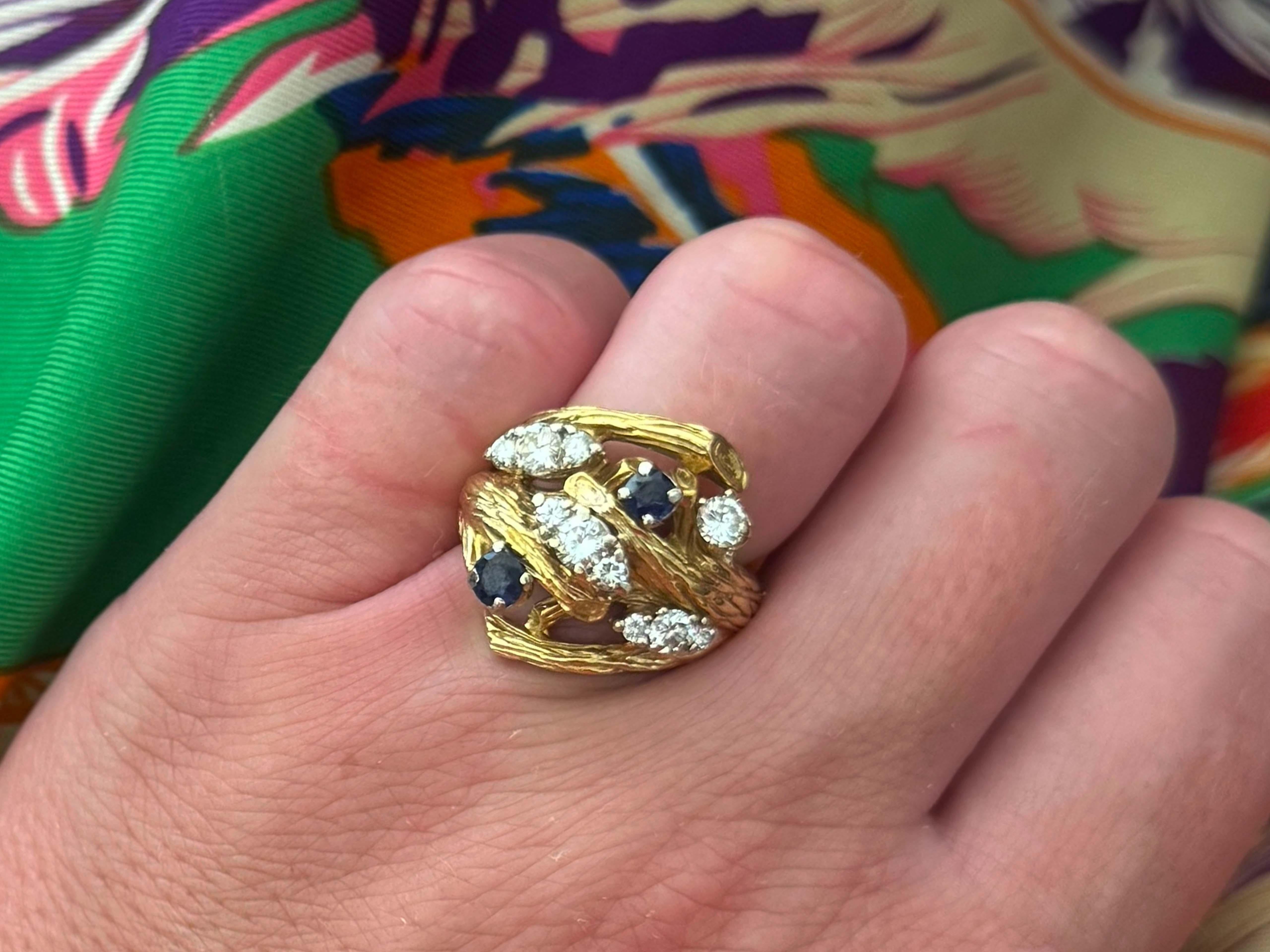 Ring Specifications:

Metal: 18k Yellow Gold

Total Weight: 12.9 Grams

​Sapphire Count: 2 round sapphires 
​
Sapphire Diameter: ~3.4 mm and ~3.8 mm
​
​Sapphire Carat Weight: ~0.35 carats

Diamond Count: 10 brilliant cut

Diamond Color: G

Diamond