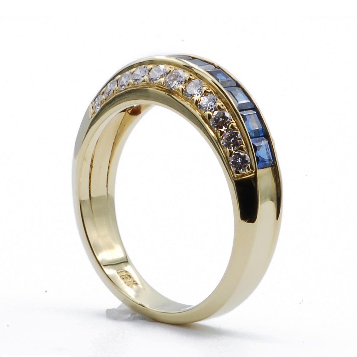 Elegant 18k yellow gold ring features three rows of stones along the top of the ring creating a slender dome.  There are two rows of prong set round diamonds along the side on an angle and a channel set row of rich blue square cut sapphires along