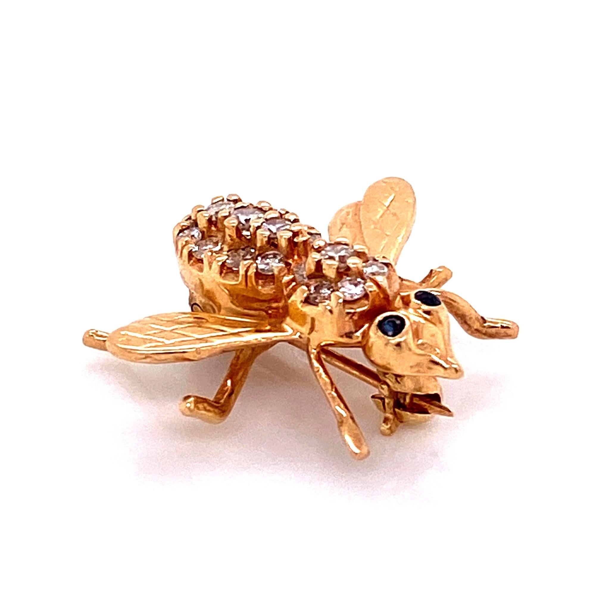 Simply Beautiful, Stylish and finely detailed Diamond Bee with Sapphire Eyes Brooch Pin hand pave set with Diamonds, weighing approx. 0.26 Carats on its back and dark vivid blue Sapphire eyes. Hand crafted in 14 Karat yellow Gold. The Pin is in