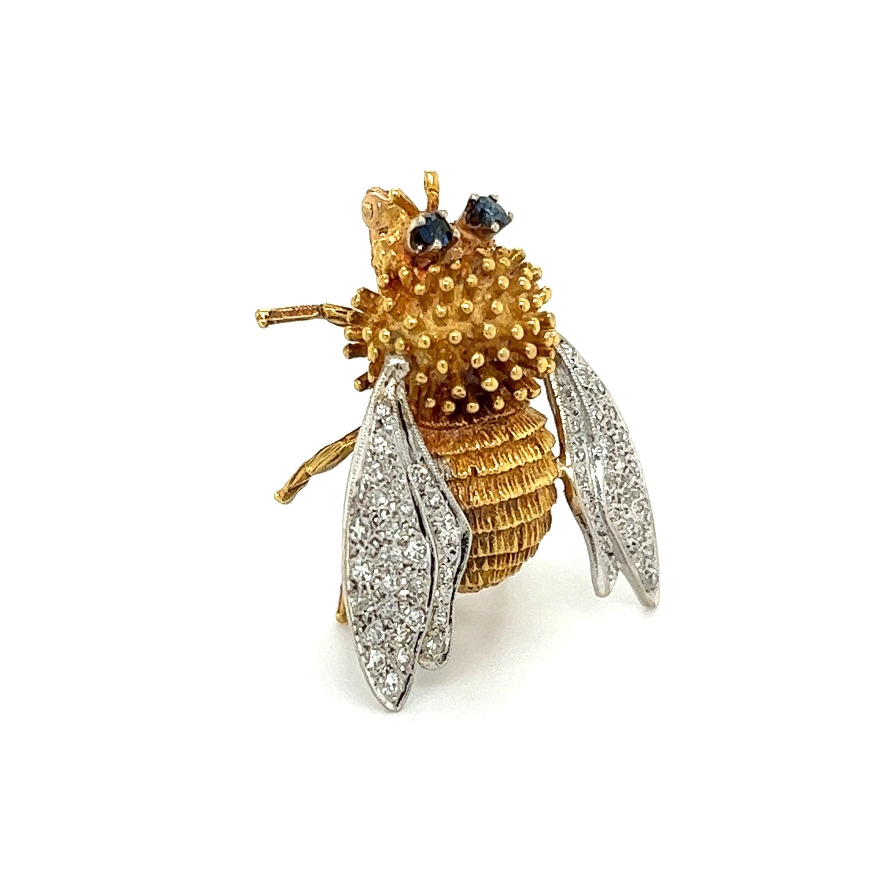 Simply Beautiful! Stylish finely detailed Diamond Bee with Sapphire Eyes Gold Brooch. Hand pave set with 52 round Diamond on wings, weighing approx. 0.70tcw and vivid blue Sapphire eyes, approx. 0.16tcw. Hand crafted in 18 Karat 2-Tone yellow Gold.