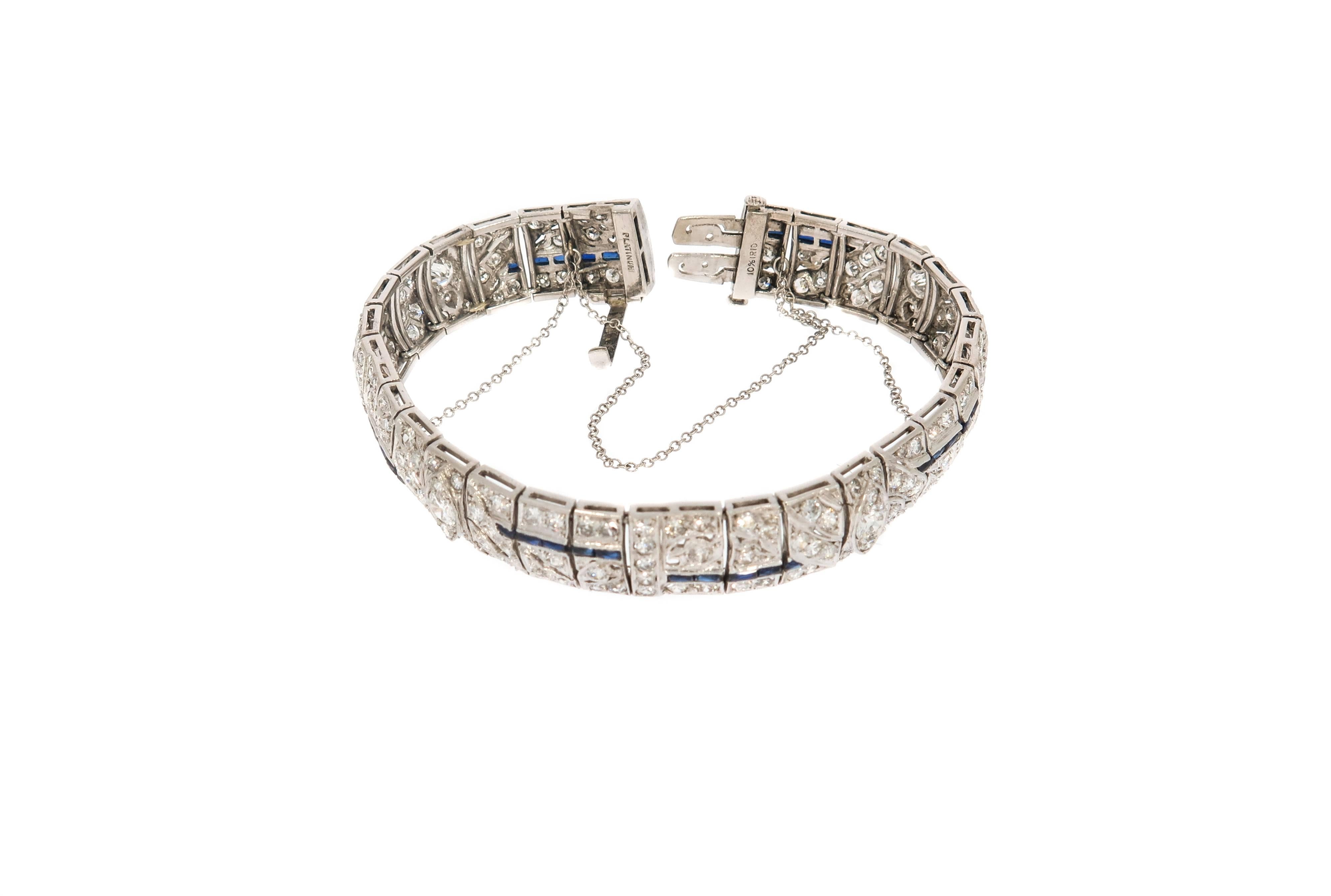 Architecturally-styled diamond bracelet, designed with round-cut diamonds and faceted baguette-cut blue sapphires meeting in an exceptional vintage design. Beautiful motif of round-cut diamonds, accented with straight design pattern of faceted