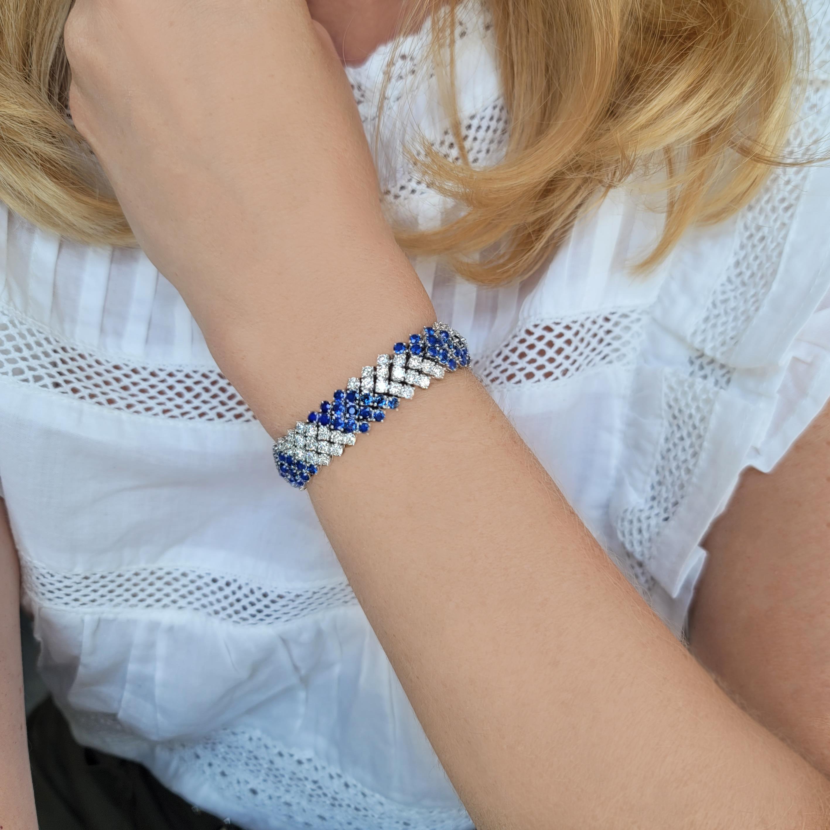 This bracelet has 5 rows of prongs set 110 brilliant cut diamonds weighing approximately 8.8ct and 120 round sapphires weighing approximately 12ct, all set in platinum. Total weight is 51.9 grams. Width: 13mm,  Length: 7.5 inches.