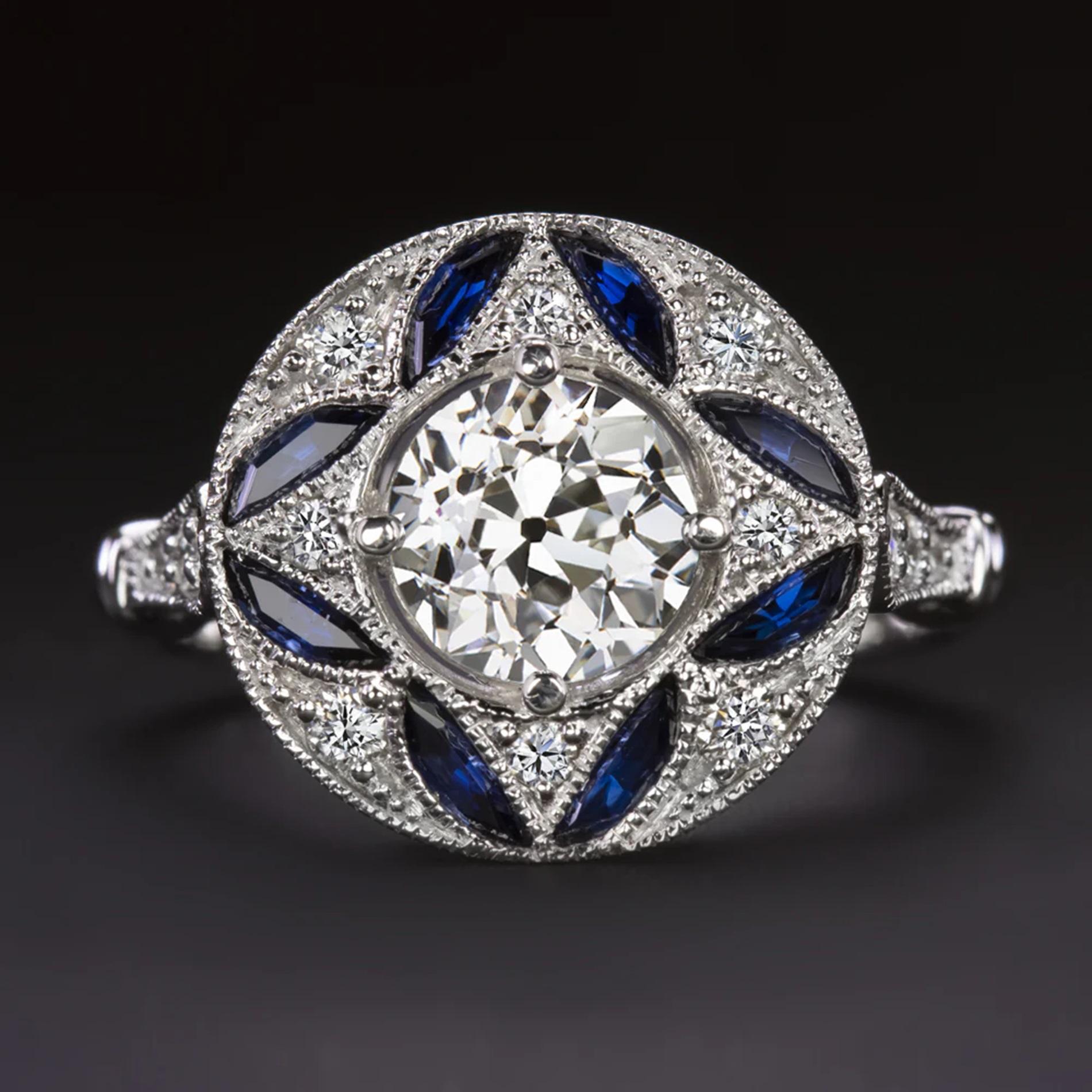 Questo anello con diamanti e zaffiri offre uno splendido design geometrico, un colore ricco e uno splendore sostanziale! Caratterizzato da un diamante antico di taglio transitorio da 0,87 carati, l'anello ha un design a cerchio splendidamente