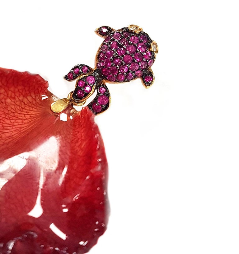 Capturing a moment of beauty for eternity, these floral and fauna-inspired post back earrings are vibrant in their use of real flower petals, detail and incredible colours.

A pair of fuchsia fish appear to 