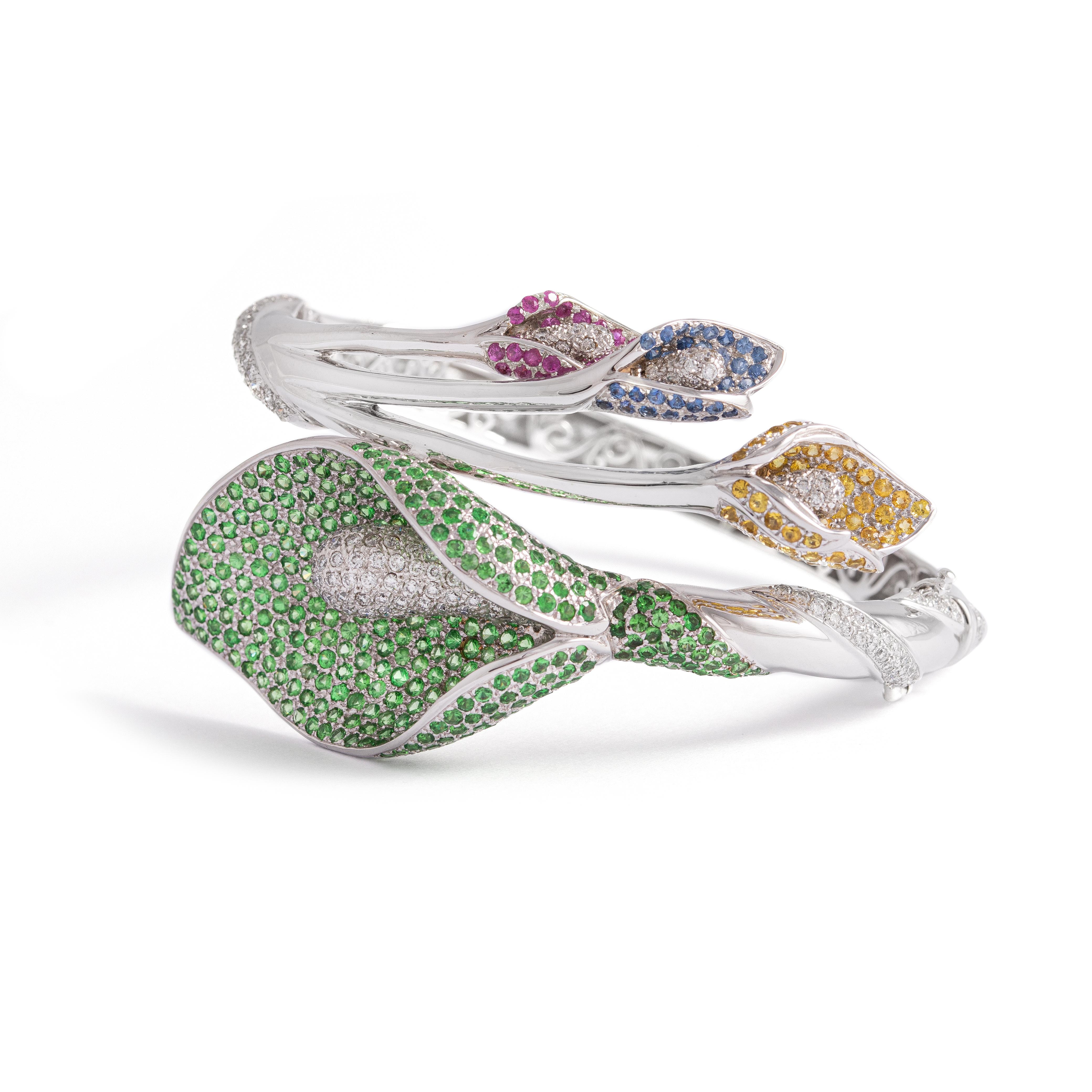Bangle in 18kt white gold set with 301 diamonds 4.92 cts, 26 pink sapphires 0.53 cts, 343 green sapphires 7.12 cts and 36 sapphires 0.61 cts and 53 yellow sapphires 1.25 cts.

Inner circumference: Approximately 16.95 centimeters ( 6.67