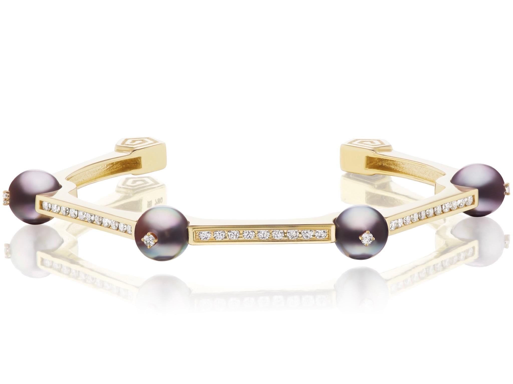 Four perfectly round 8.5mm Sea of Cortez Silver Grey Pearls make up this contemporary bracelet by Andrew Glassford.  It contains .76 carats of G/H VSI round diamonds between the pearls and is fashioned as a bangle with 45 degree angles all around