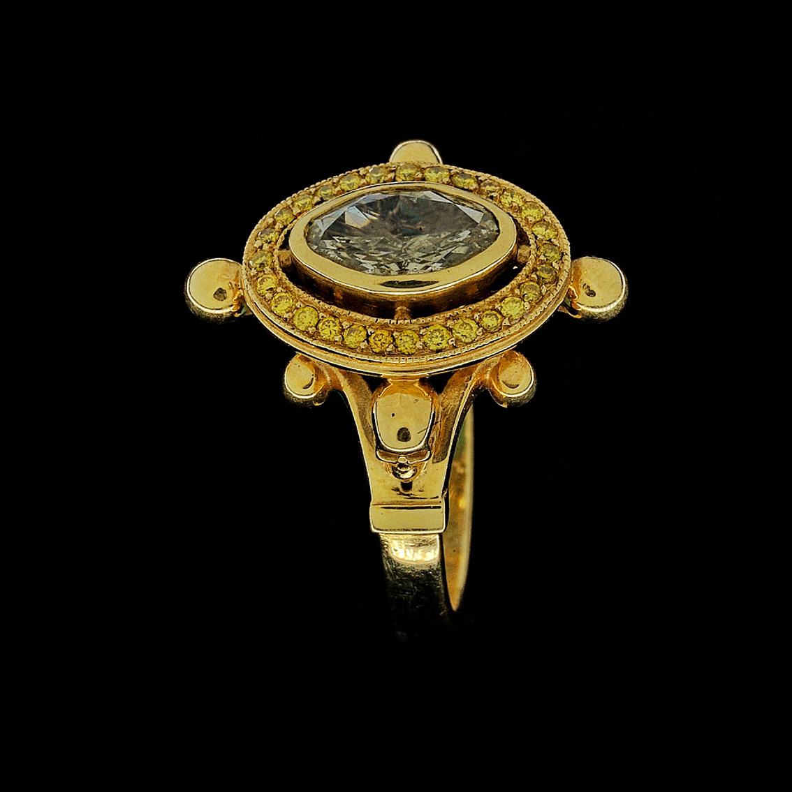 This 18kt yellow gold ring with diamonds and skulls is dark opulence at it's finest. 

This high fashion gothic statement ring is handmade in 18kt yellow gold, featuring a central bezel set oval cut diamond, 1.02ct in weight, (8.91mm x 5.68mm) SI in