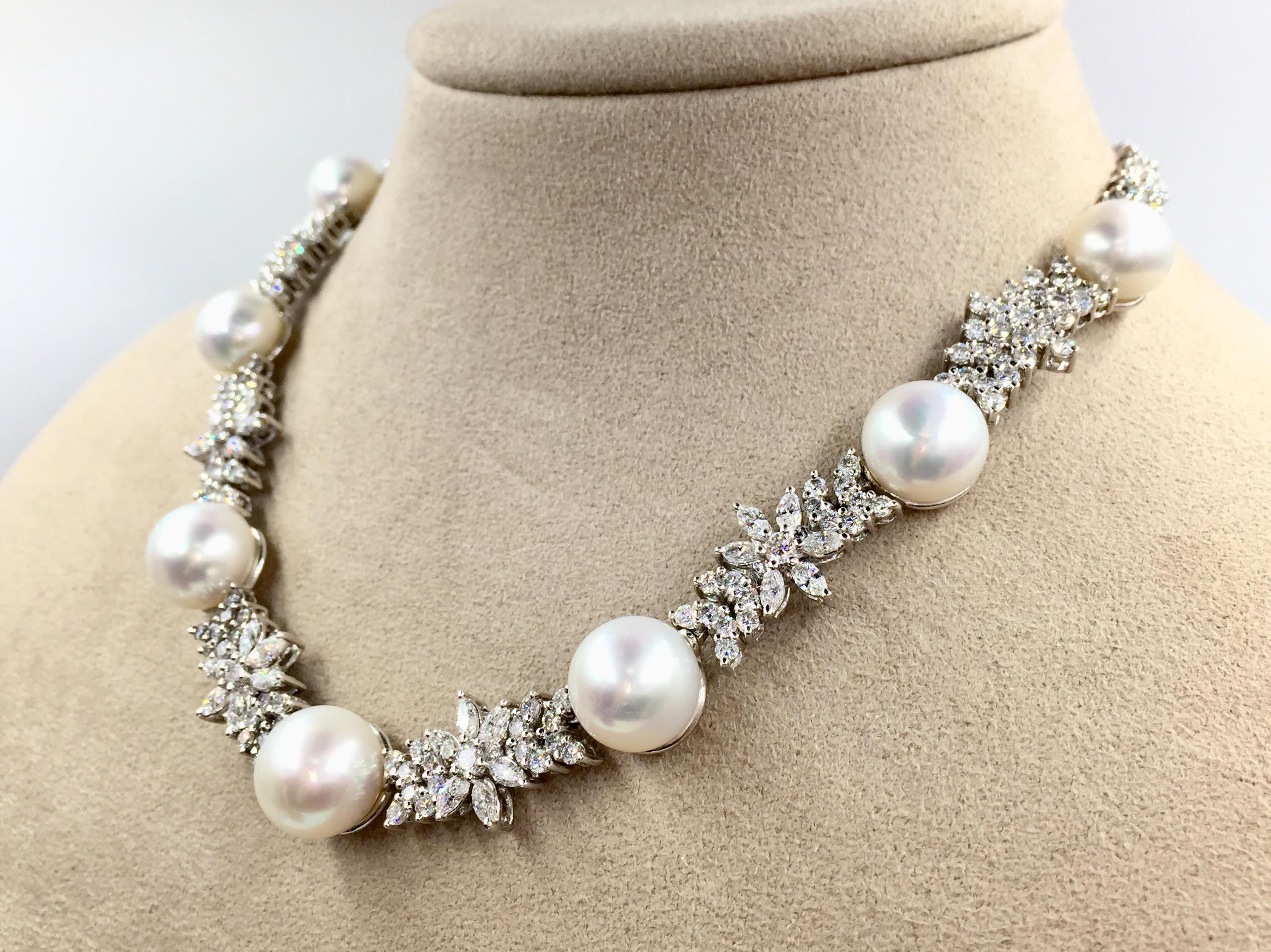 A truly immaculate find. This gorgeous platinum necklace features 13.98 carats of round brilliant diamonds and 2.78 carats of marquise brilliant diamonds. Diamond quality is approximately G color, VS2/SI1 clarity. Seven white, lustrous and slightly