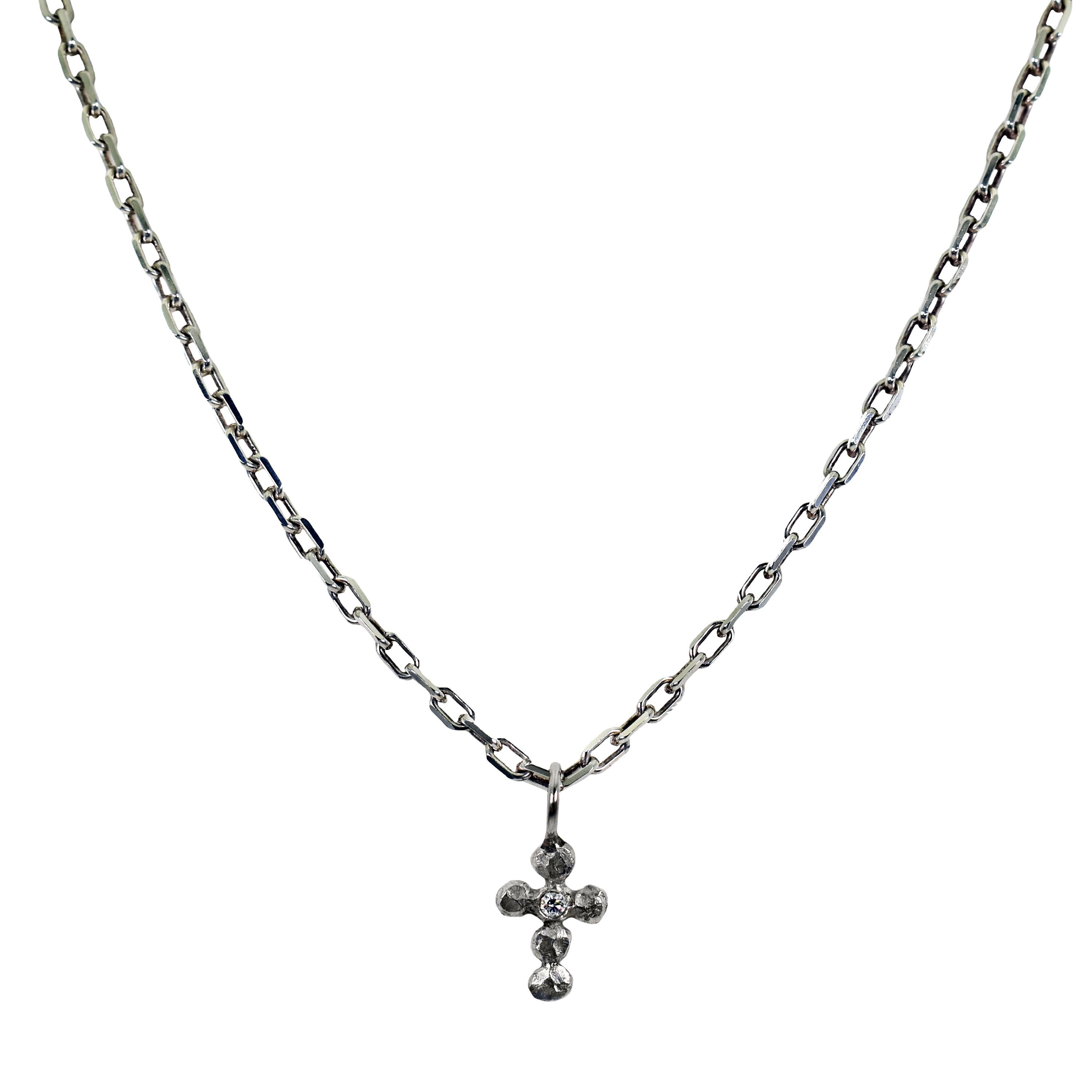 Diamond and sterling silver bubble cross pendant on a 16 inch sterling silver chain necklace. Cross pendant is 0.81 inch in length. 