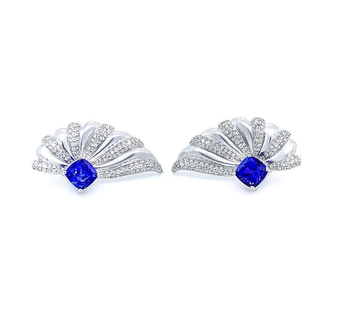 Dreamy tanzanite cushions in these airy, angel-wing earrings in 18 karat white gold are surrounded by alternating sections of diamond micro-pavé and textured surface.

•	Total Diamond Weight: 1.30 carats 
•	Tanzanite Weight: 3.57 carats
•	Diamond