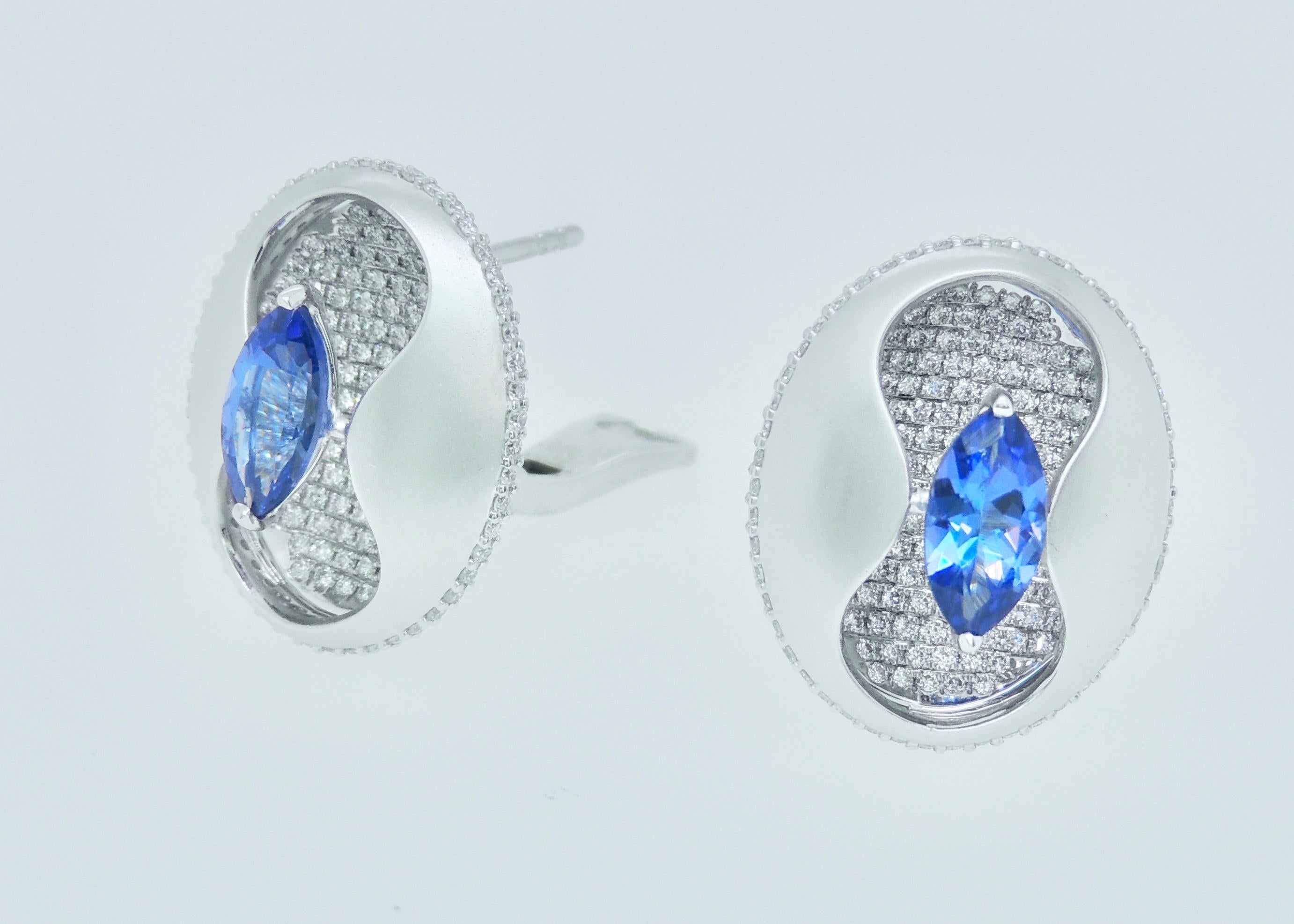 Exquisite pear-shaped tanzanites appear to float above a carpet of micropavé diamonds in these stunning earrings made with textured gold. 

The matte finish of the gold contrasts beautifully with sparkling, white diamonds and royal blue of the