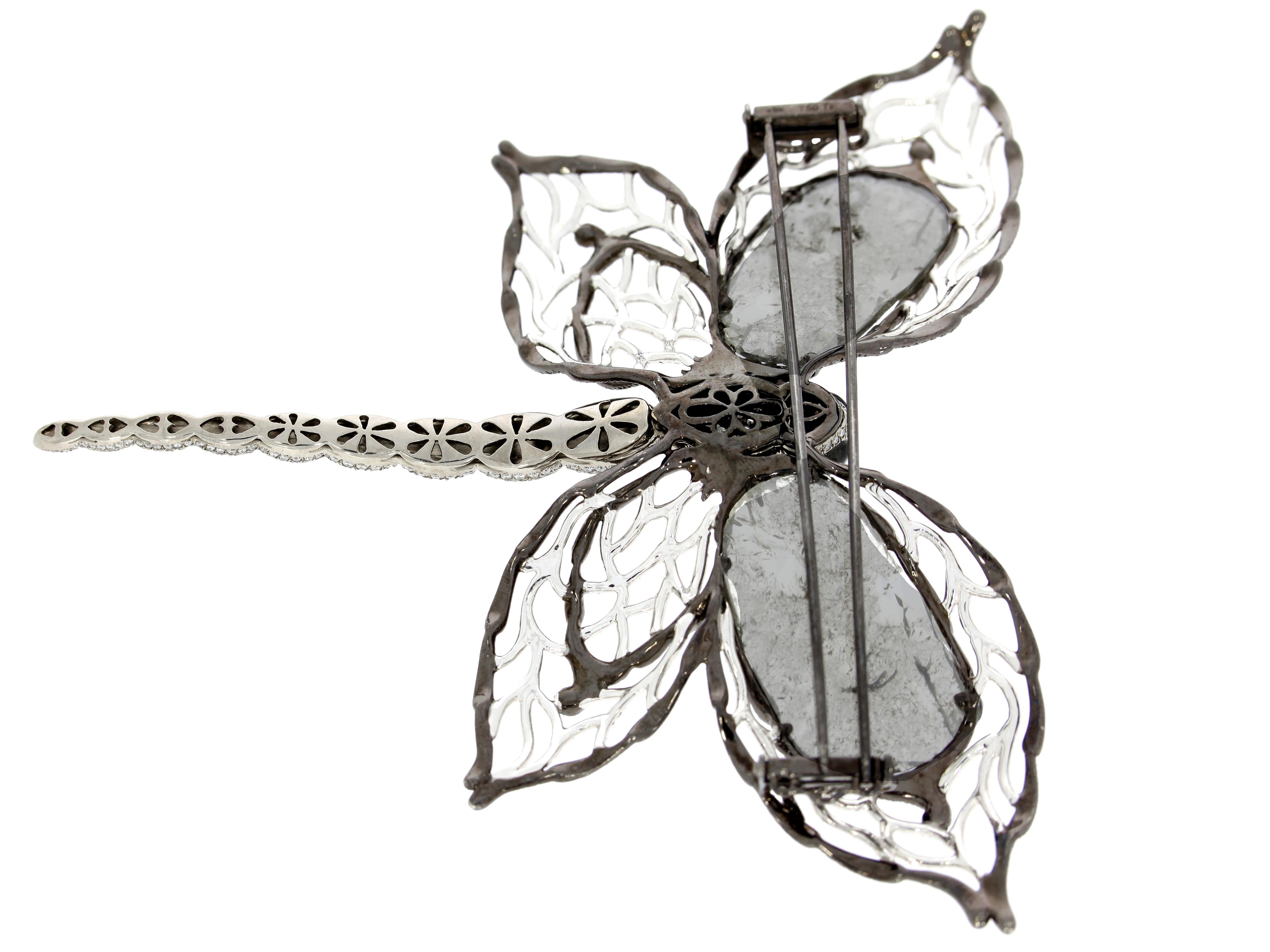 Delicate diamond dragonfly brooch by Chatila with tiger's eye on the eyes and tail, creating a beautiful contrast of color. The diamonds on the wings were meticulously applied without a backing in order to create a transparent stained glass