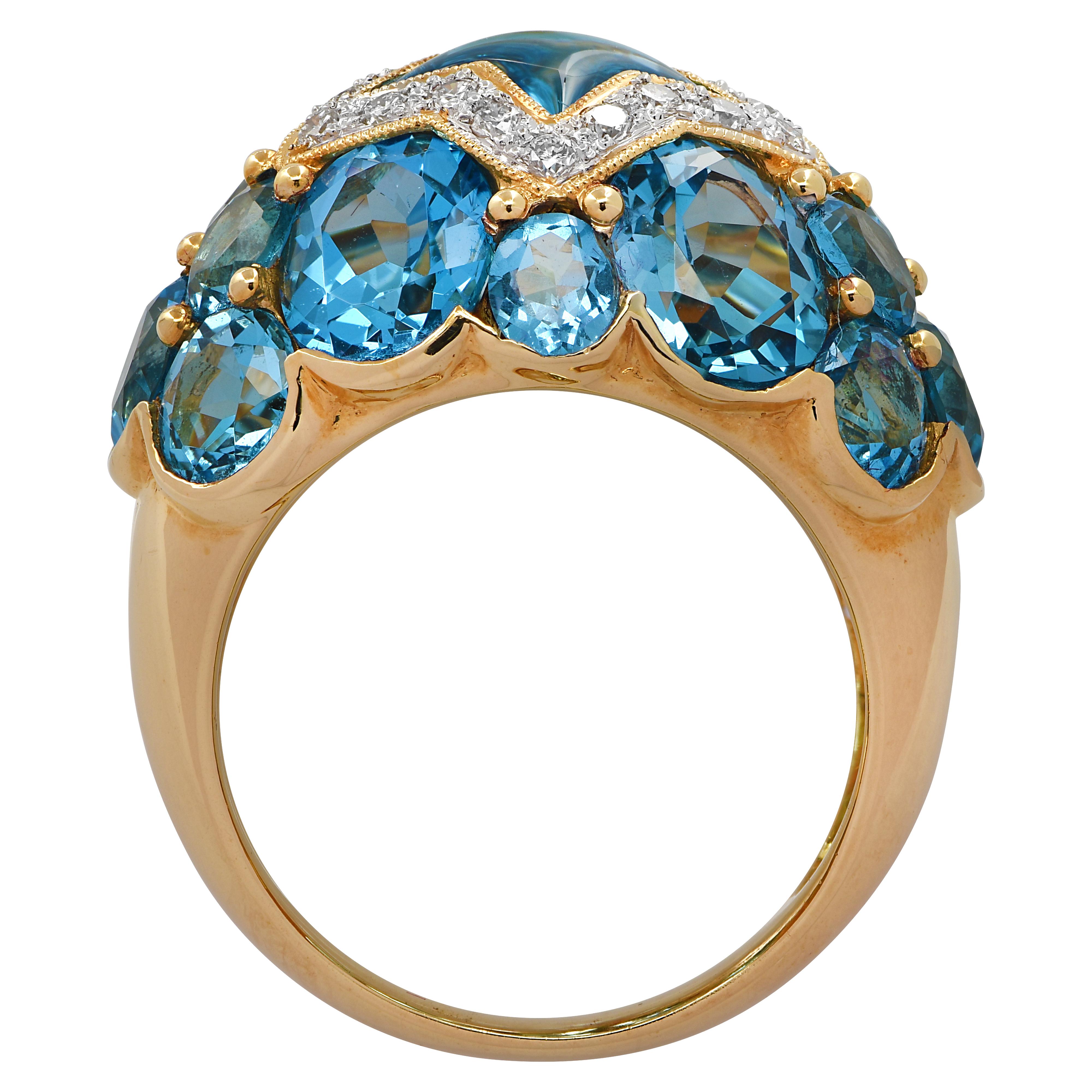 Enchanting ring crafted in 18 karat yellow gold featuring a star shaped fantasy cut Topaz framed in 20 round brilliant cut diamonds weighing approximately .32 carats total H color, SI clarity, and oval shaped Topaz. This delightful ring measures