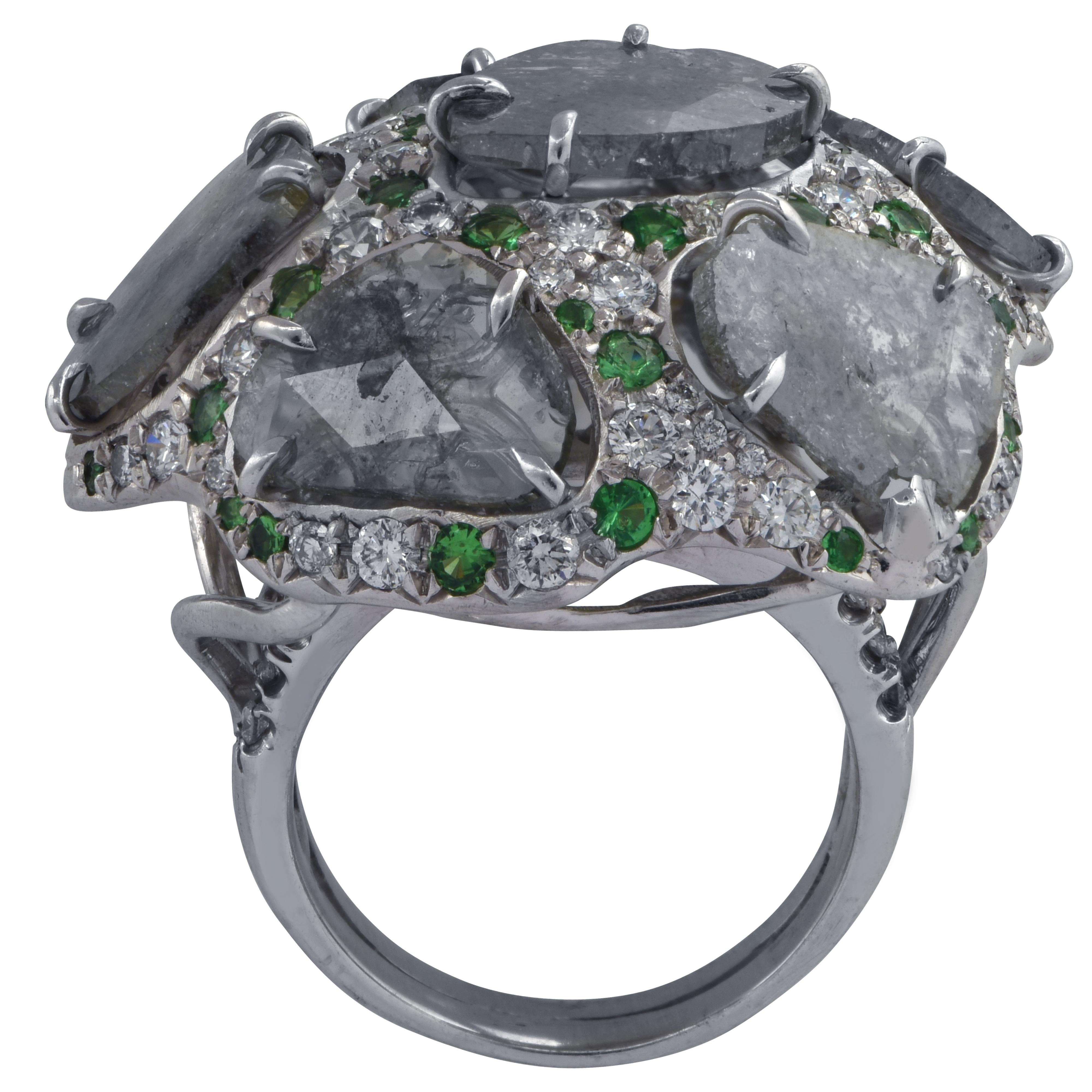 Striking domed ring crafted in 18k white gold featuring 5 diamond slices weighing approximately 10 carats total, accented by 80 round brilliant cut diamonds weighing approximately 1.30 carats total, G color VS clarity and 30 Tsavorite Garnets
