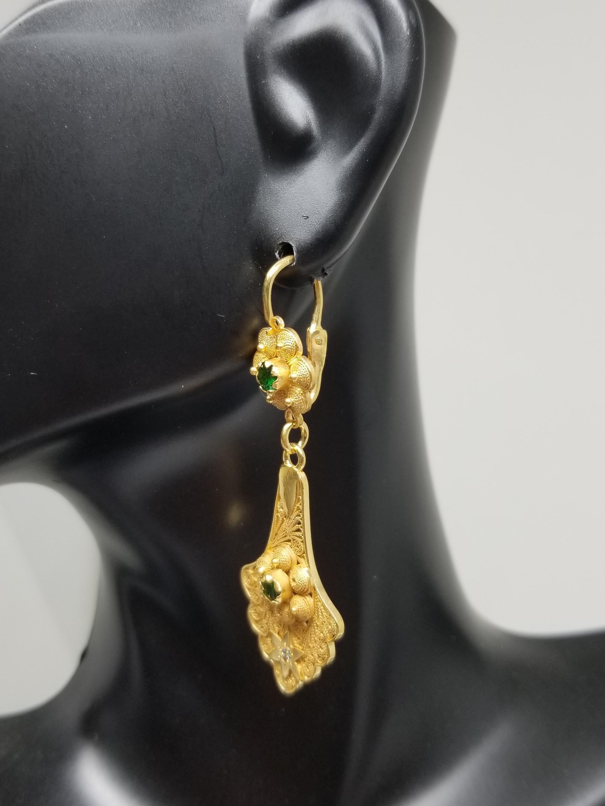Diamond and Tsavortie Dangle Earrings, containing 2 round diamonds weighing .09pts. and 2 tsavorite weighing .66pts. set in an 18k yellow gold plated filigree dangle setting.