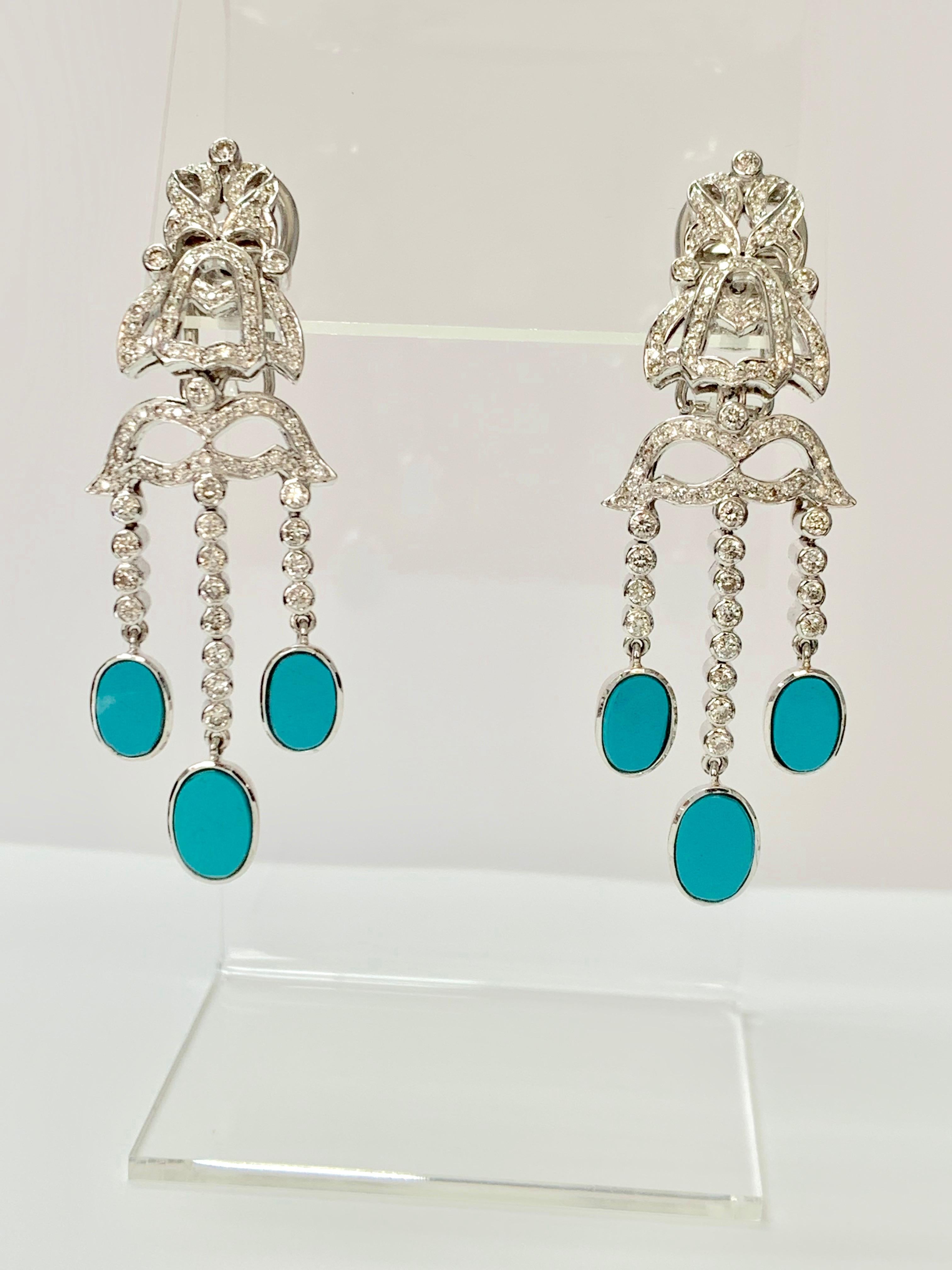 Diamond and turquoise earrings in 18k white gold. 

The details are as follows ; 
Diamond weight : 2 carat approx ( GH color and VS clarity ) 
Metal : 18k white gold 
Measurements : length : 2 inches 
Turquoise weight : 5.20 carat 
Gold weight :