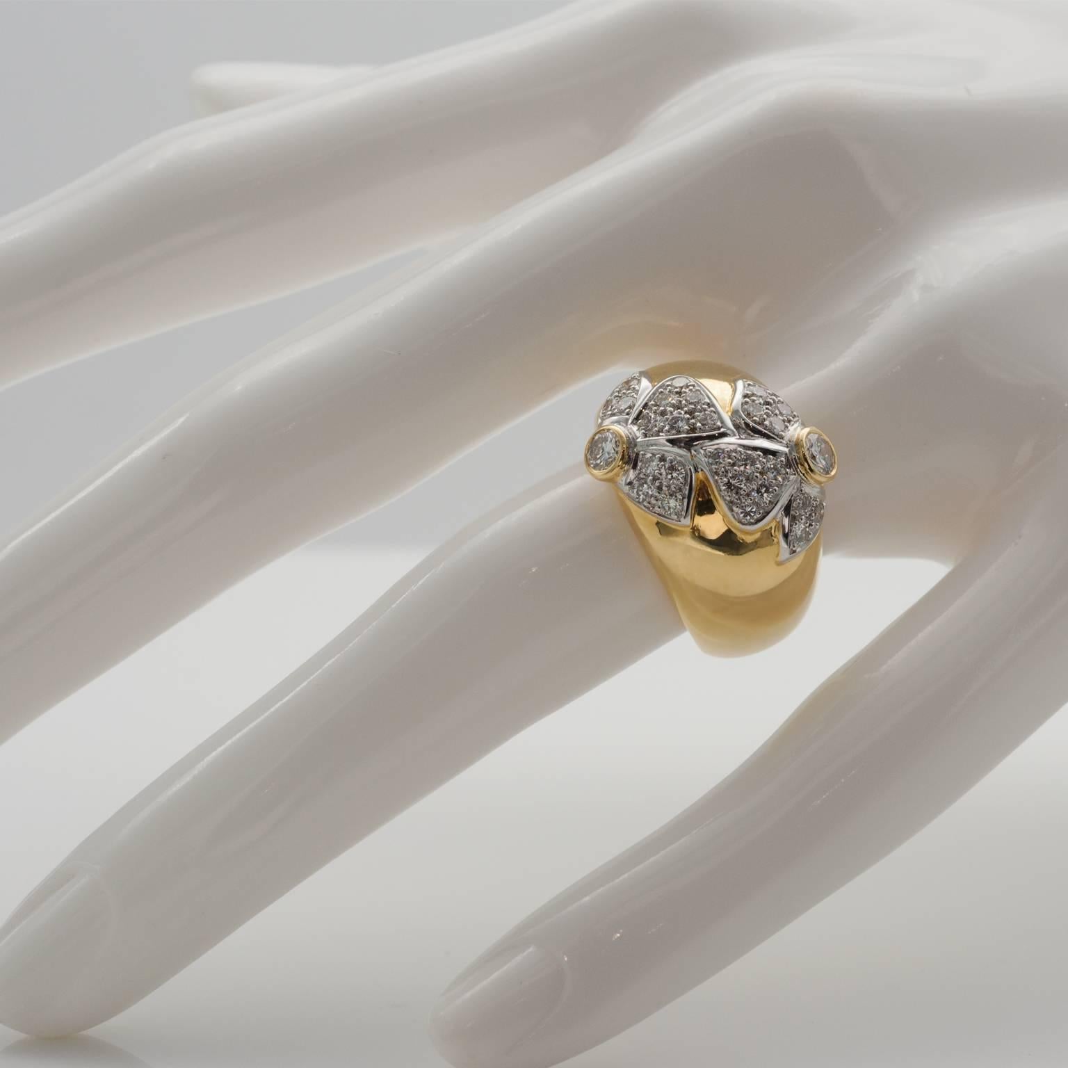 Exquisite dome ring, Two delicate white gold flowers set with diamonds on a yellow gold domed ring. Very pure design; elegant and poetic.
Diamonds : approximately 0.85 carat , The two bigger diamonds are about 0.15 each