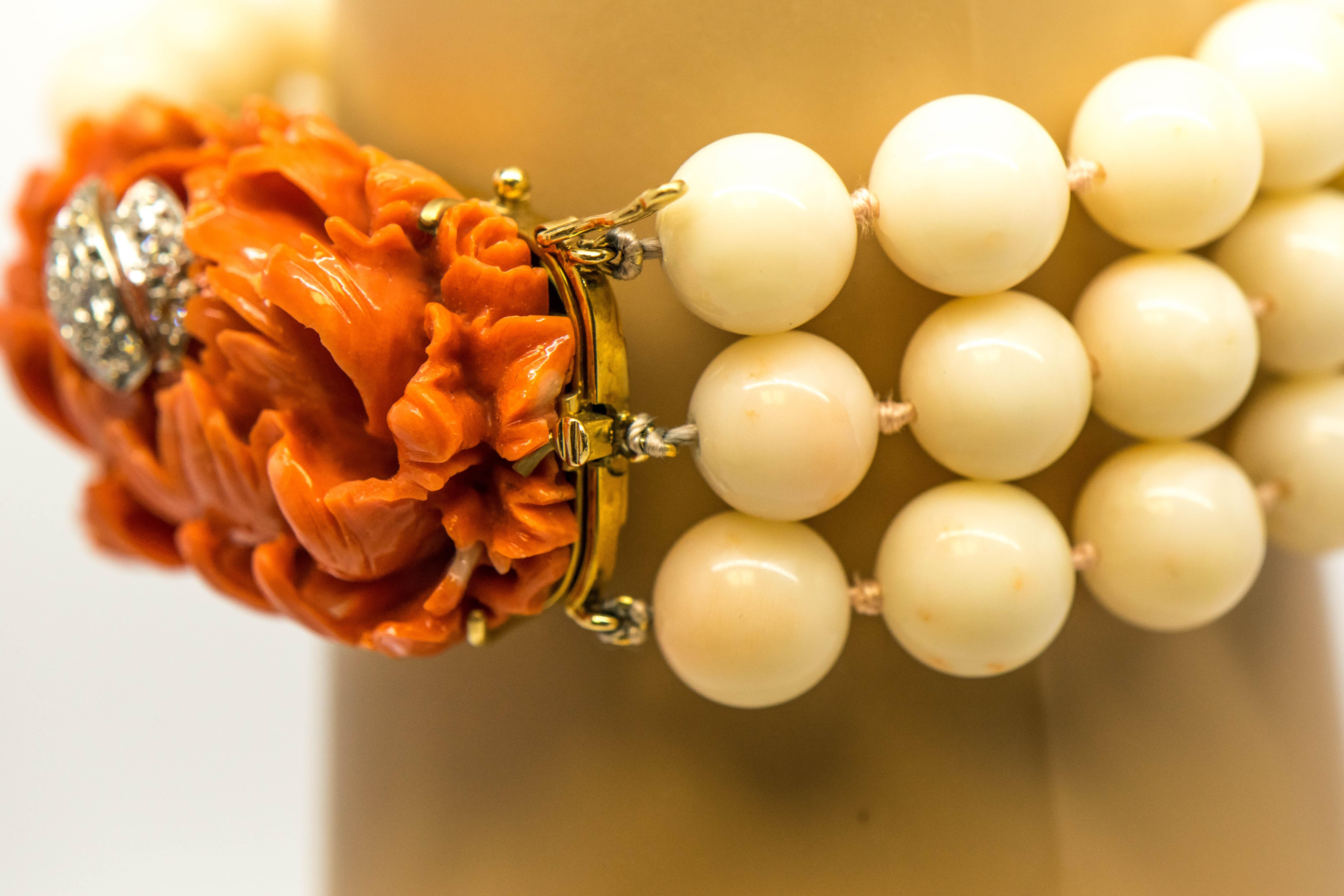 This is a magnificent Diamond and Coral Multi-Strand Bracelet that is so artistically designed, you must see the photographs!  Placed in a gracefully carved Coral Flower Rosette are (13) Round Brilliant Cut Diamonds, G-H in Color, VS in Clarity for