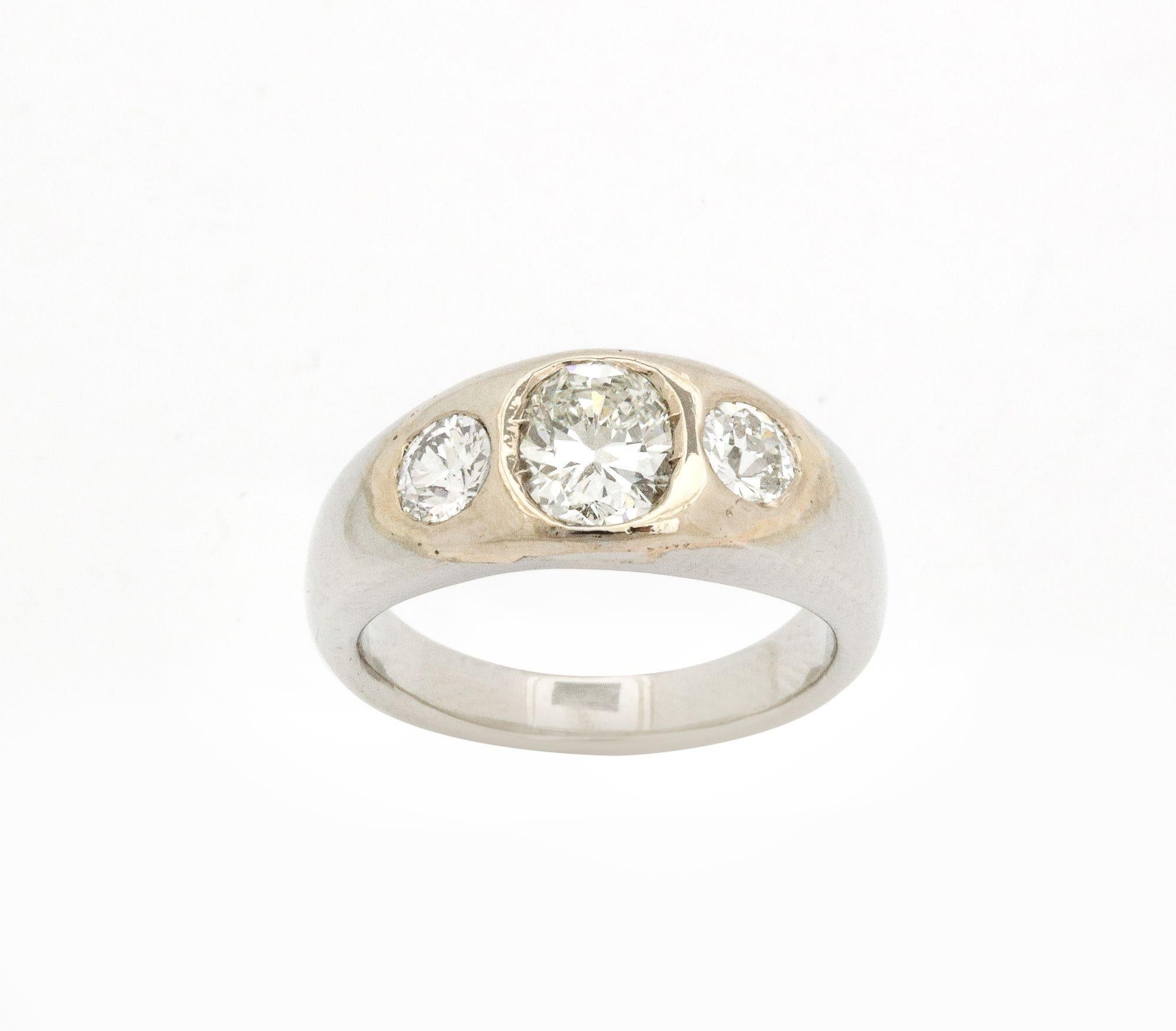 A great Diamond and White Gold and Gold Flush Mount  Ring. A larger diamond flanked by two smaller stones .80 cts set in 14k gold