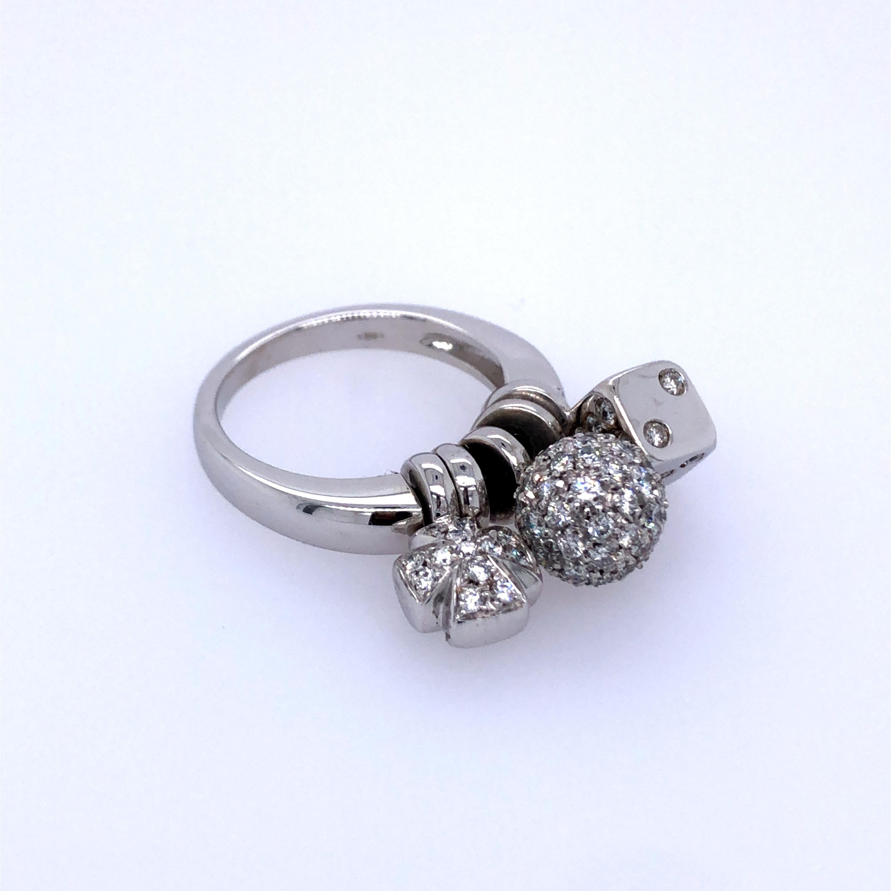 Of three articulated charms, a die, sphere, and Maltese cross, pavé-set with round brilliant-cut diamonds
18k white gold Ring size 7; Gross weight 13.9g 8.9 dwts 