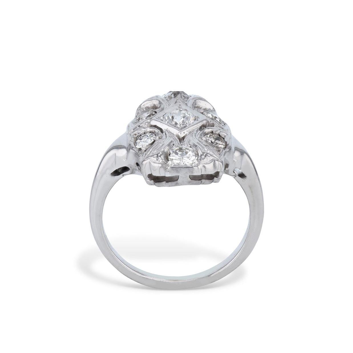 A stunningly exquisite diamond and white gold estate panel ring, crafted with 14 kt. white gold and featuring 7 glittering Old European Cut Diamonds. Delightfully unique, this ring adds an enchanting touch of vintage glamour to your